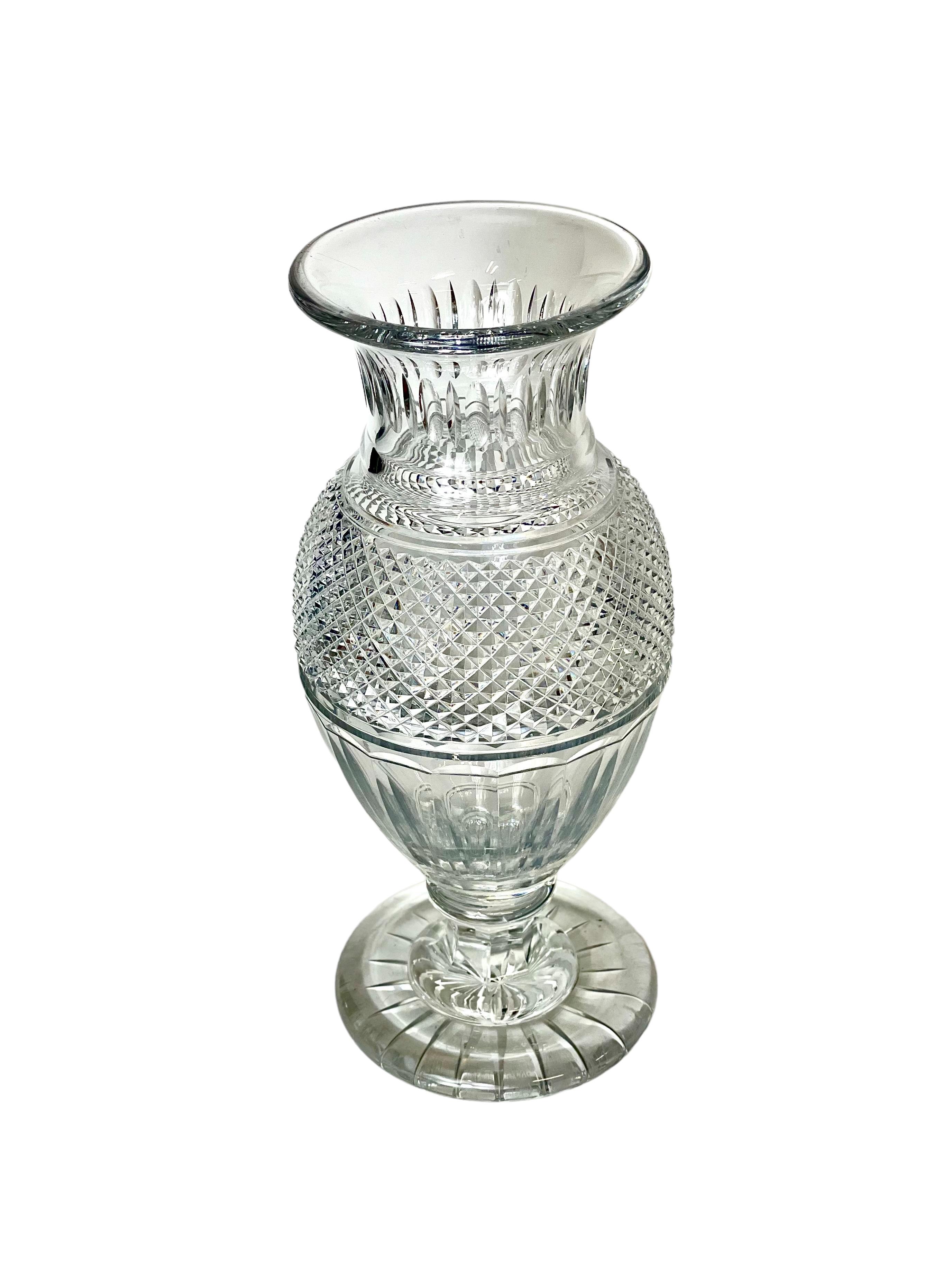 A slender and timeless Baccarat Musée des Cristalleries vase, cut with a broad band of fine diamonds on the upper section, with vertical flutes below, resting on a circular star-cut foot. This glittering vase is a beautiful example of Baccarat