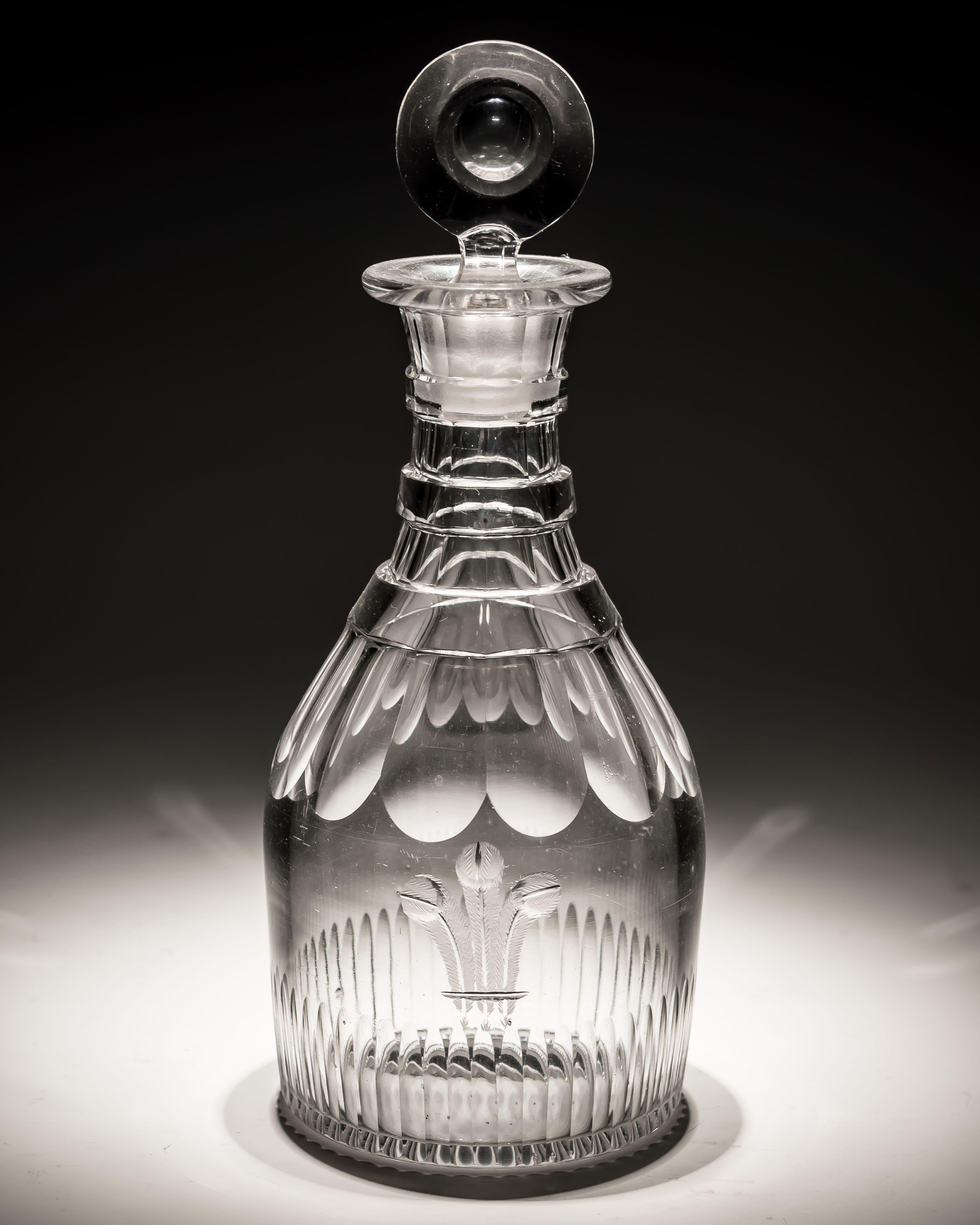 A slice and flute cut glass spirit decanter engraved with the prince of Wales feathers fitted with target stopper.

England, circa 1795.