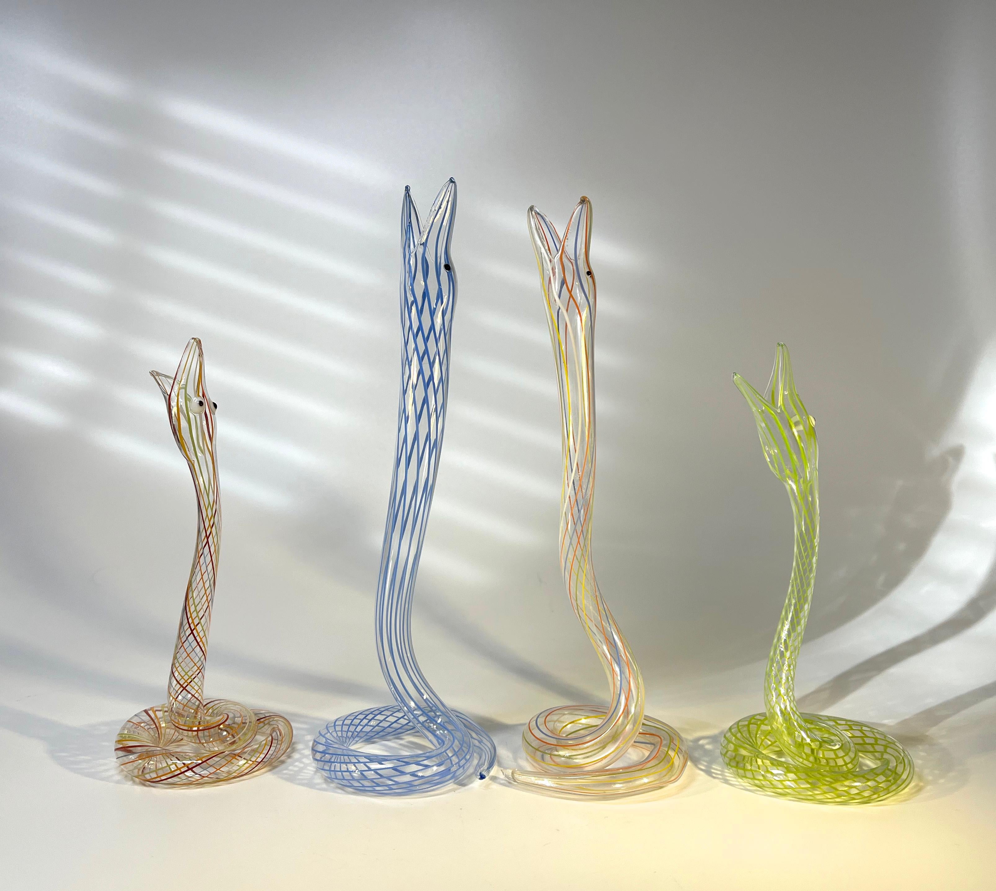 Whimsical gathering of four lamp work Art Deco glass snake vases by Bimini of Austria
Colours are pale blue, mid green and two multi-coloured
Circa 1920 - 1930
Measures: Tall Snakes Height 8 inch, Diameter 2.75 inch
Small Snakes Height 6 inch,