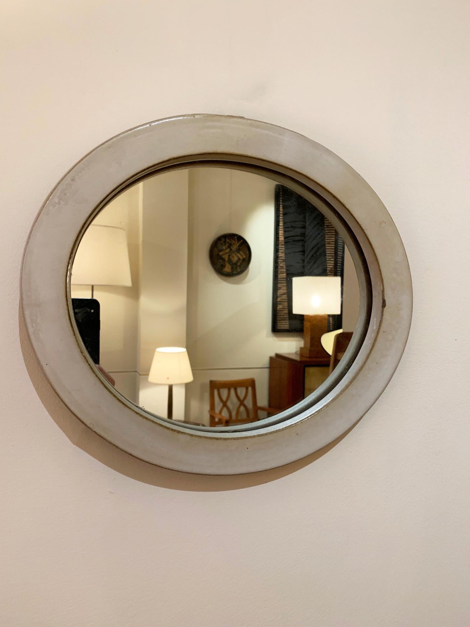 A small oval stoneware ceramic mirror
France, circa 1950.