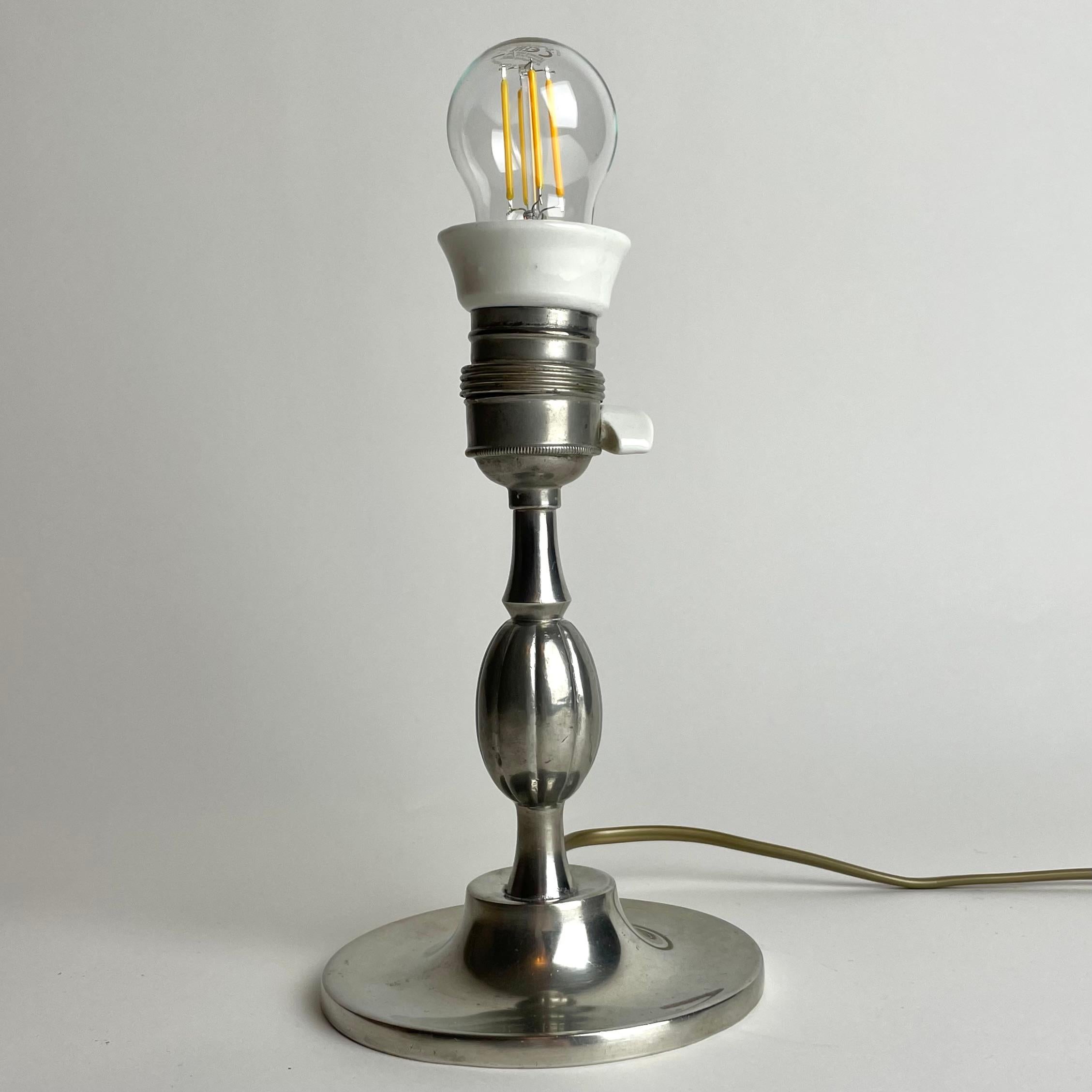 A small and elegant Table Lamp in Pewter. Swedish Grace from the year 1930 (D8). The table lamp has the original lamp holder.

Wear consistent with age and use 