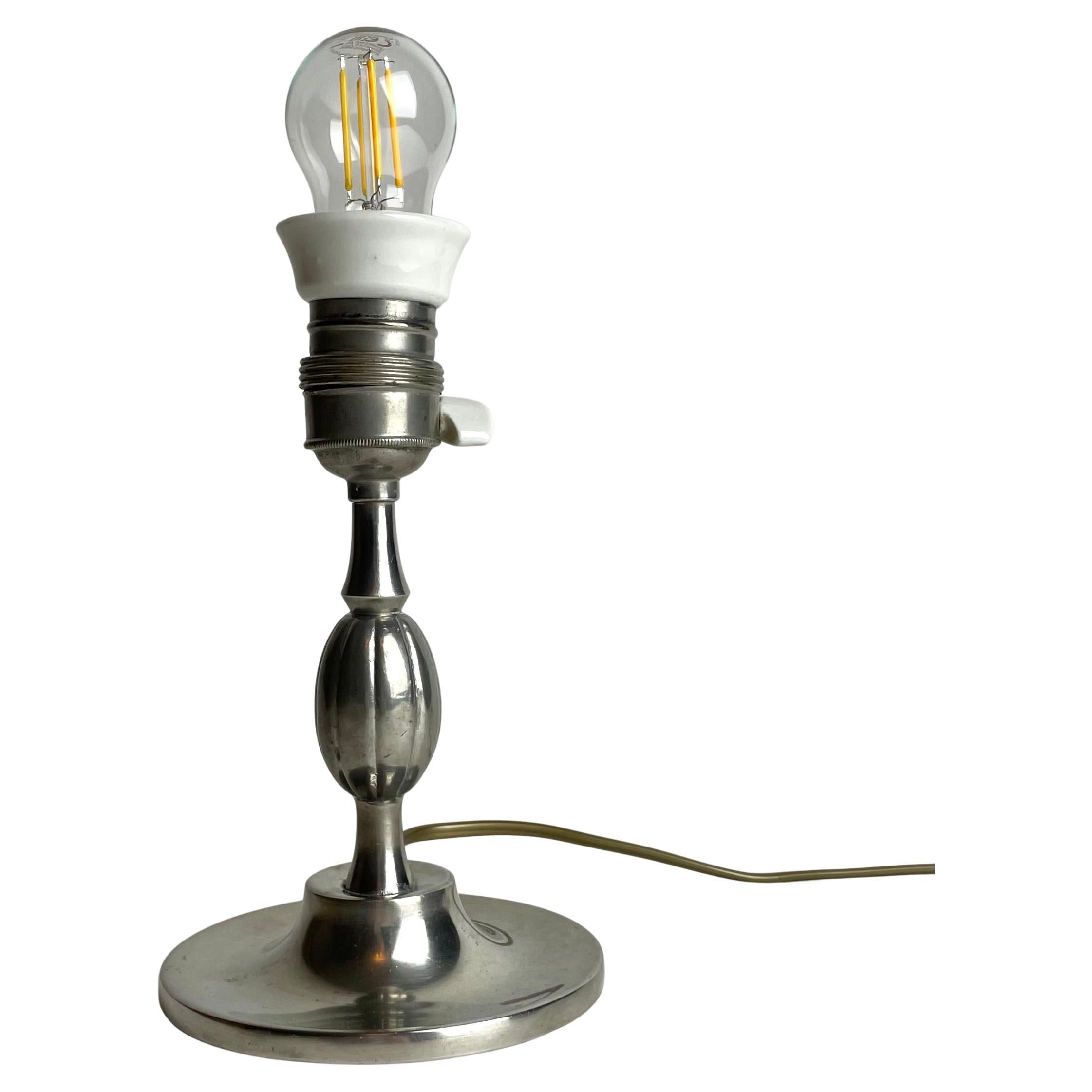 A small and elegant Table Lamp in Pewter Swedish Grace from the year 1930.