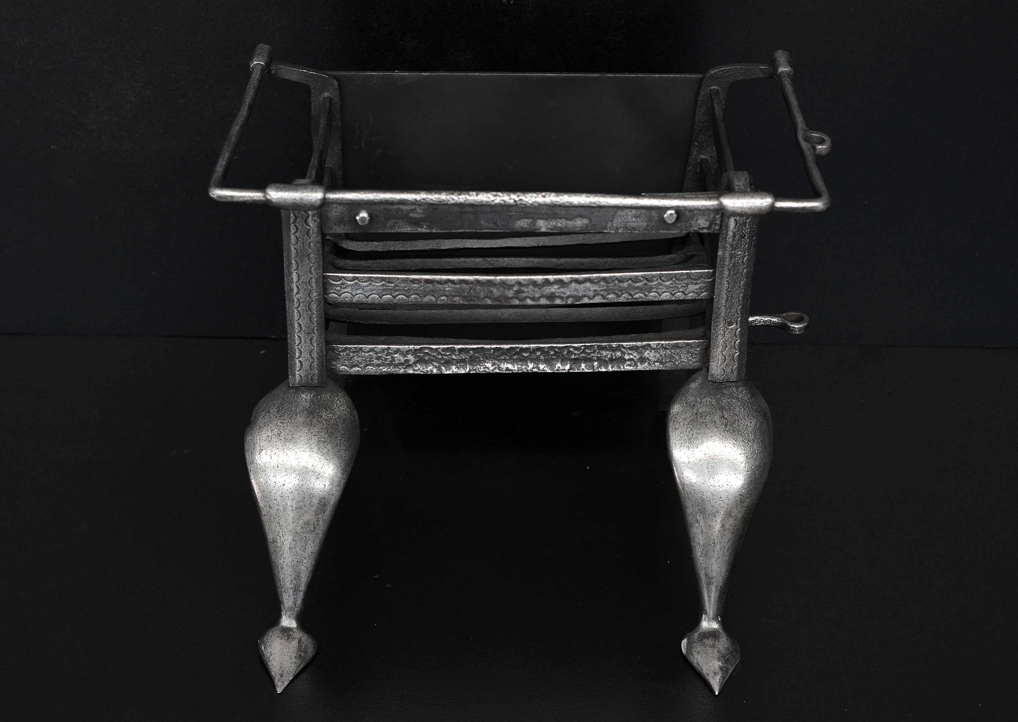 An petite polished wrought iron Art Nouveau firegrate. The shaped feet surmounted by square burning area. Early 20th century.

Width At Front:	475 mm      	18 ¾