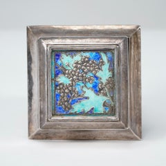 A small Arts and Crafts silver plated jewellery box with enamel decoration