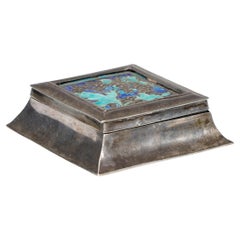 A small Arts and Crafts silver plated jewellery box with enamel decoration