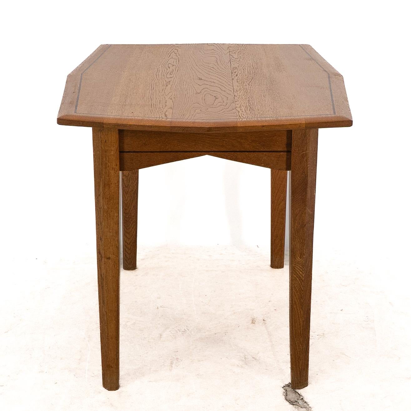 English A small Arts & Crafts Cotswold style oak dining or centre table angular designs For Sale