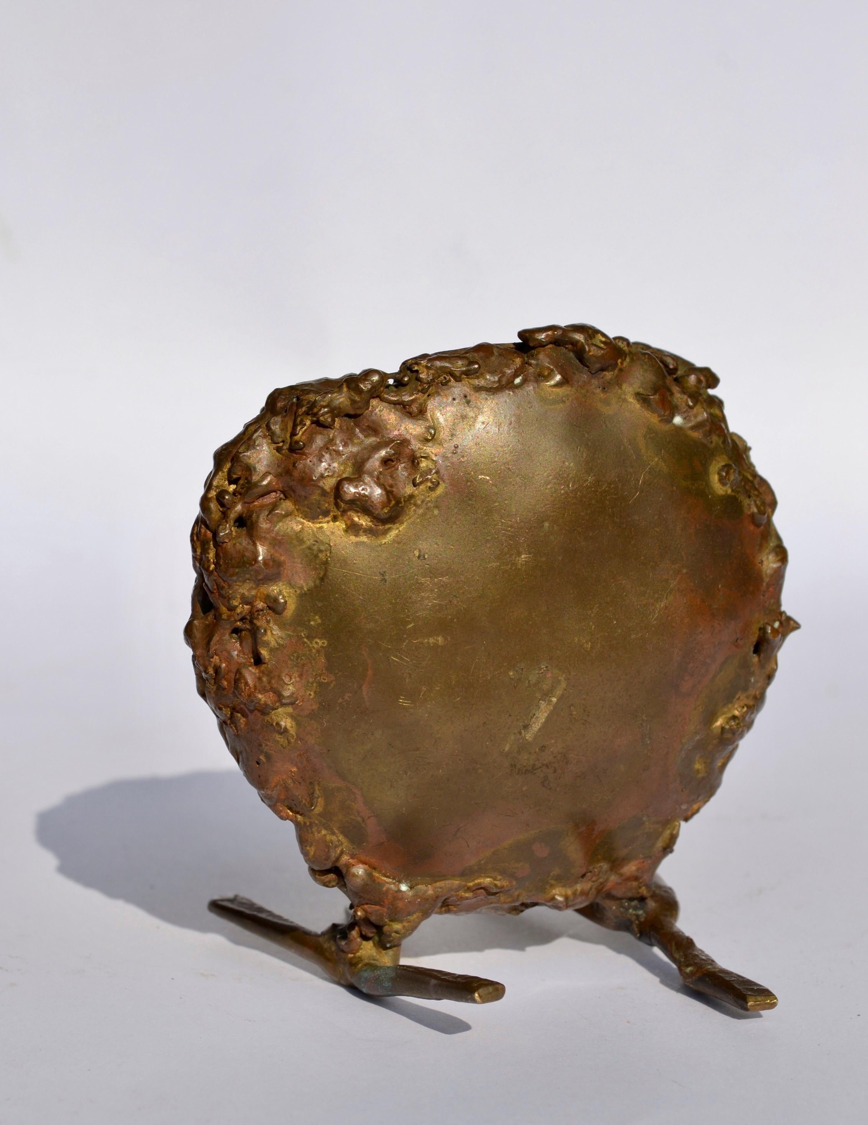 A small brass sculpture of an owl in a style reminiscent of Germain Richier or César Baldaccini. This unique piece features a textured, organic surface, marked by raw details and a handcrafted aesthetic. The irregular volumes and sculptural forms