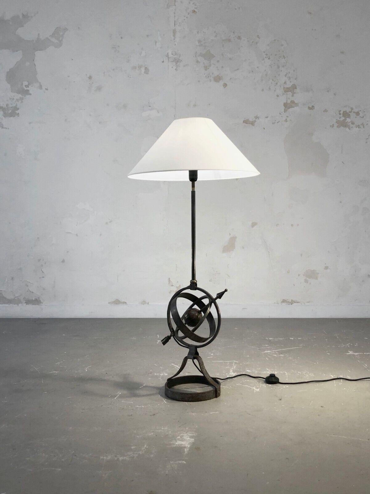 A small floor lamp or reading lamp of naval and traveler inspiration, at the crossorver of Neo-Classical and Brutalist spirits, solid wrought iron structure with a superb old world map in suspension, by Jean-Pierre Ryckaert, France