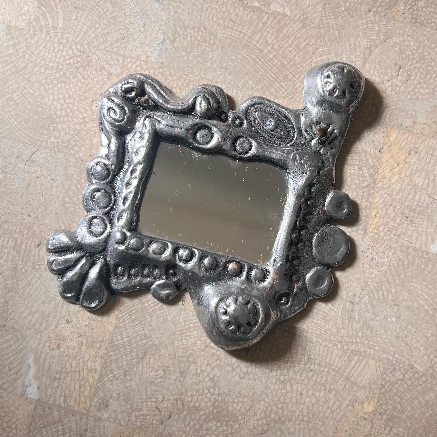 A small brutalist wall mirror by Donald Drumm, signed, 1979. Some tarnish but overall great condition. Ready to hang. Pick up in LA or we ship worldwide. 
5” x 5.25” 