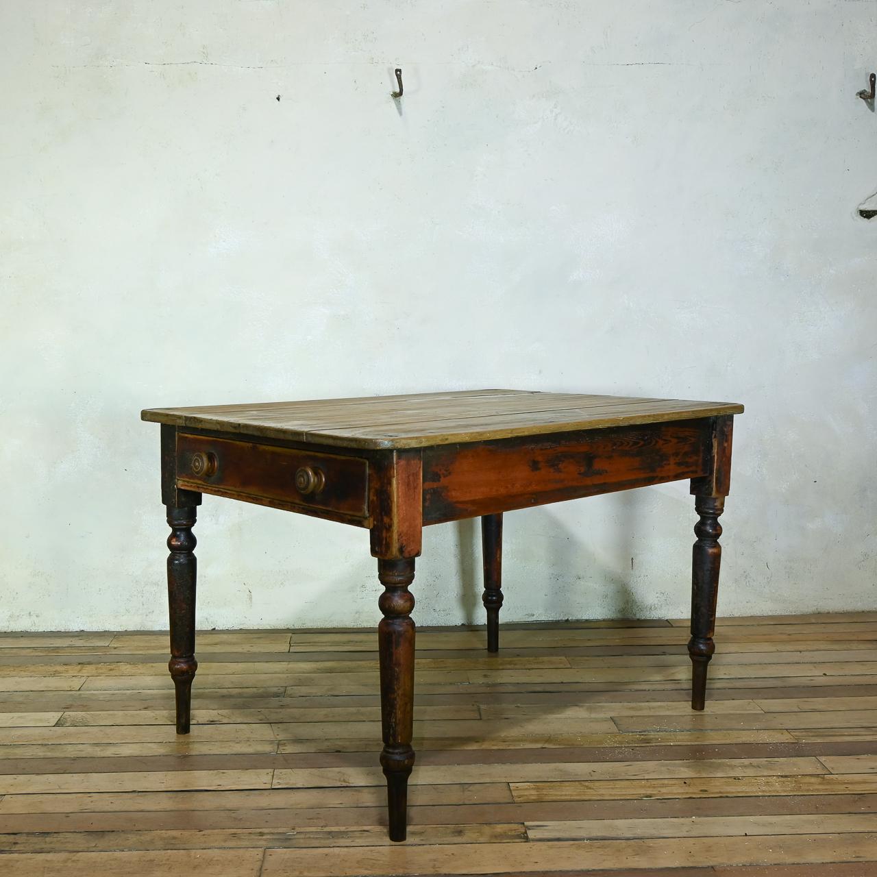 A charming early 19th century farmhouse Kitchen table. Raised on elongated turned legs featuring a lovely patina, with elements of original paint throughout. Housing a full-length deep drawer to one end of the apron.

Height - 69cm  
Width -