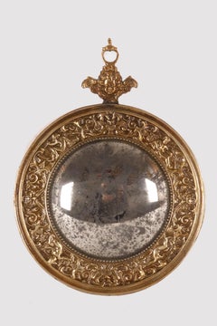 A small convex mirror, with a brass frame. Italy, late 19th century.