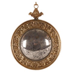 A small convex mirror, with a brass frame. Italy, late 19th century.