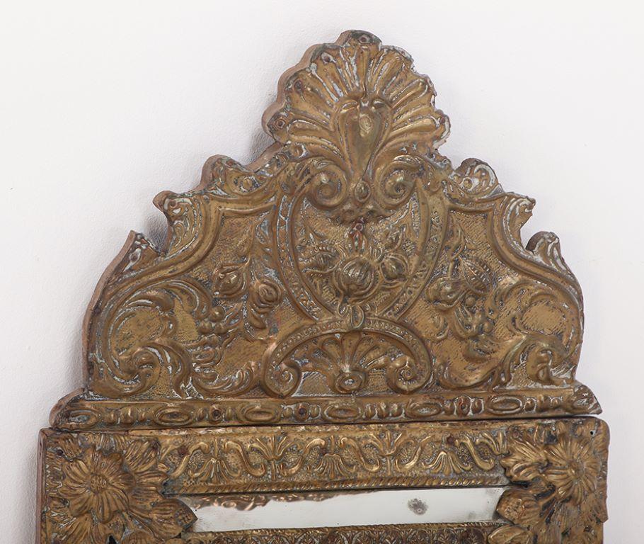 European A small Dutch style brass repouse mirror circa 1890. For Sale