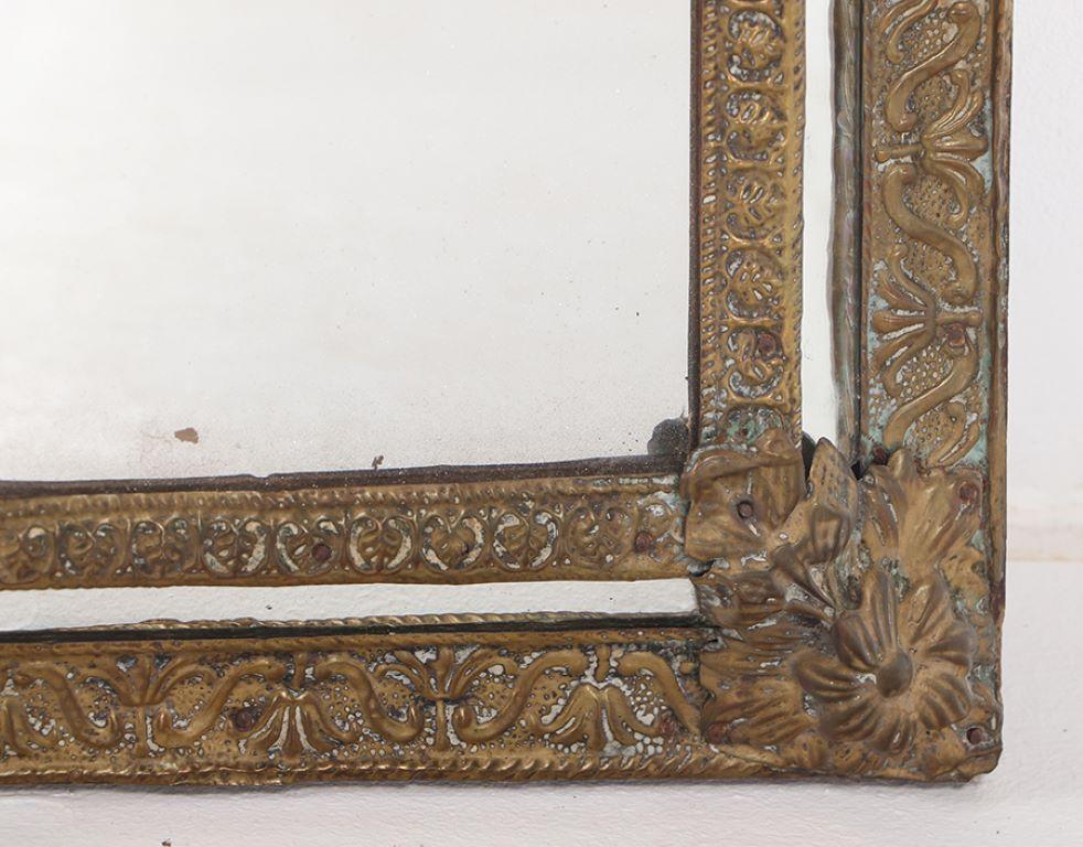 A small Dutch style brass repouse mirror circa 1890. In Good Condition For Sale In Philadelphia, PA