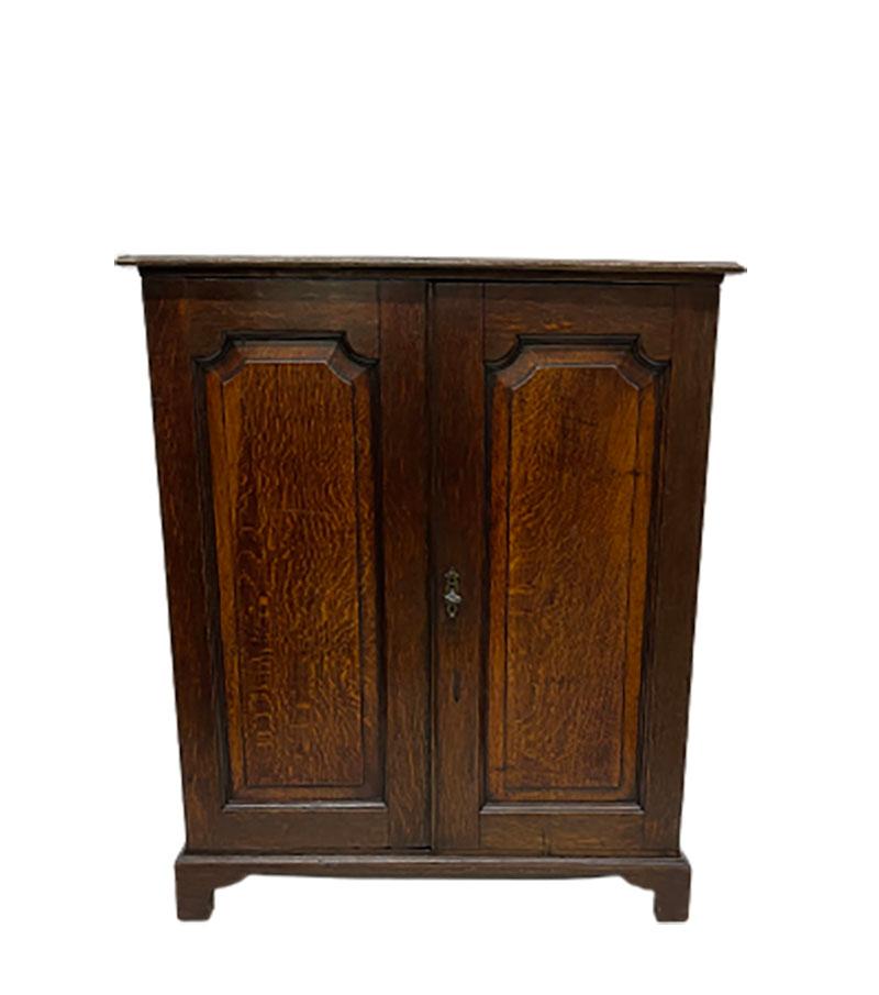 A small English 2 doors with interior oak wall cupboard, ca 1820

A lovely small English oak wall cupboard with 2 fielded panel doors and has inside an interior with a shelf and 5 drawers. 
Key present and working. The left door will be closed