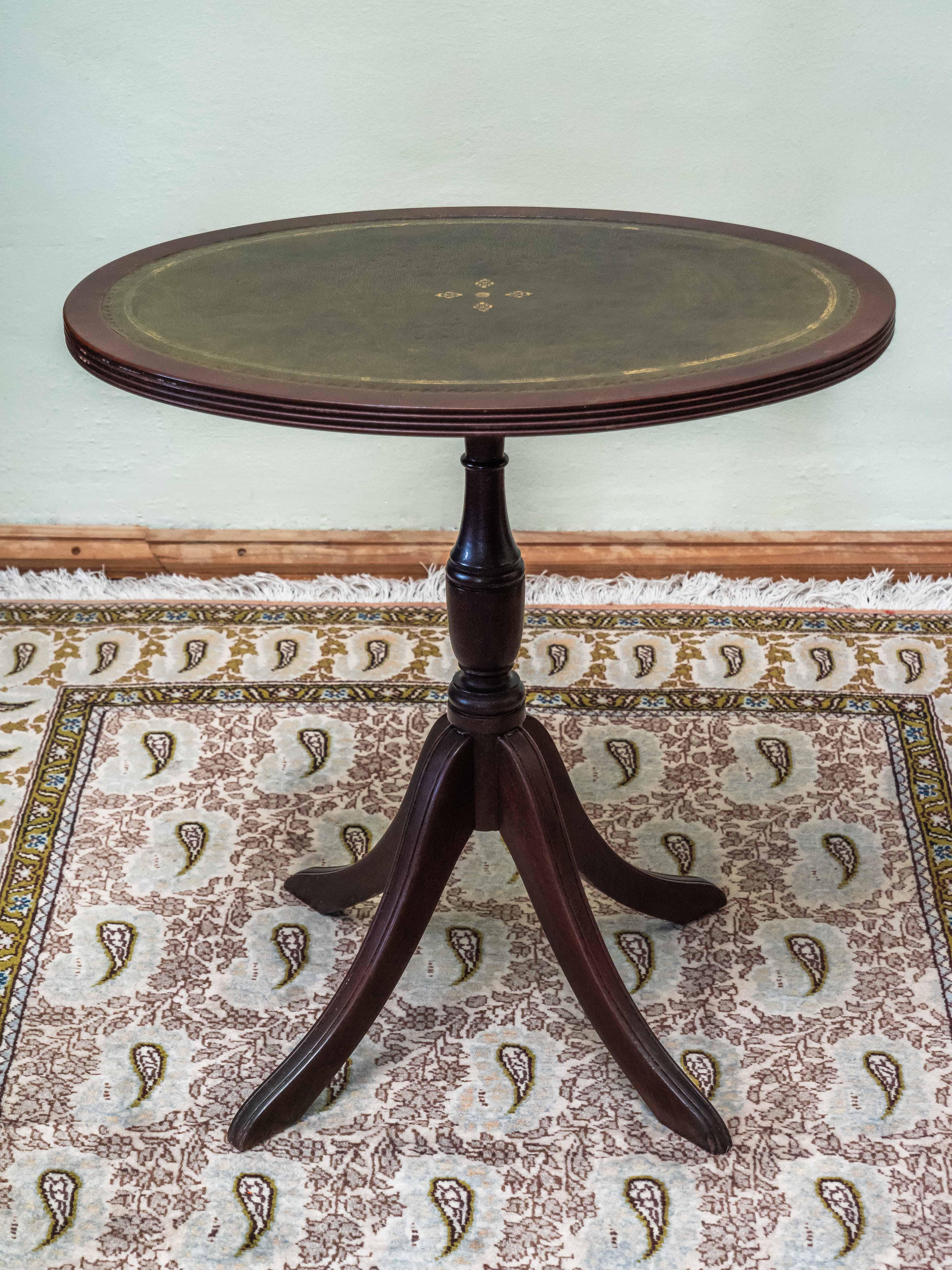 A small English side table

Classic English design in Sheraton style. Top plate decorated with gold print. Profiled lub of the top plate. The leg is turned. Condition: the table is solid, without wormholes, good condition. Date: around 1970.