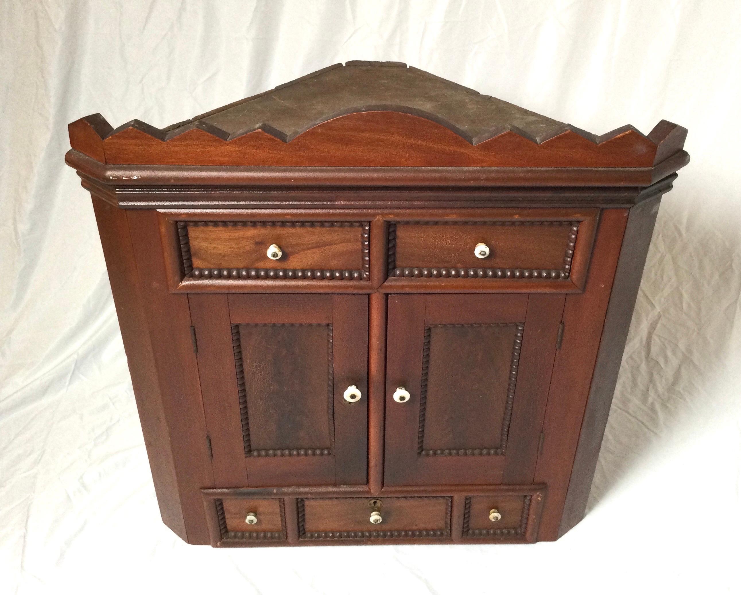 Charming medium color poplar wood cabinet with two doors with concealed compartments with drawers. Signed D.B. Branch 1915.
The cabinet with nice original finish with a natural warm patination.