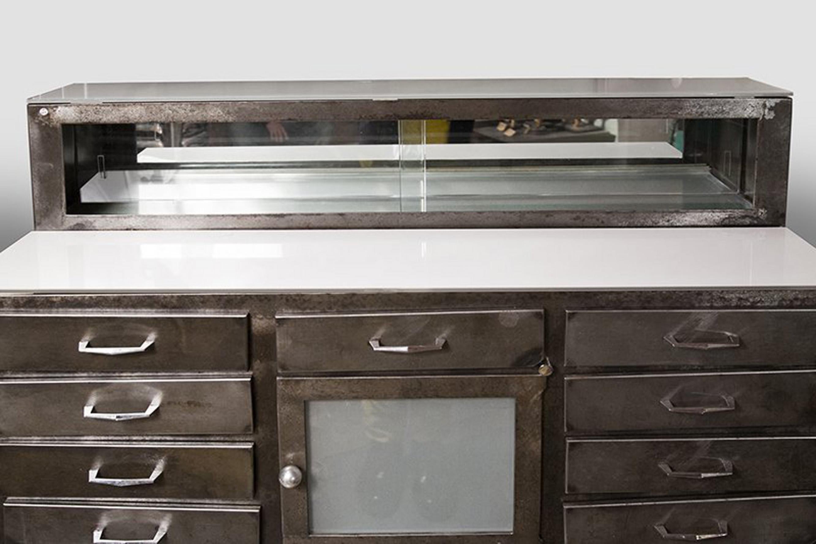 A small chest of drawers for dentist with doors made out of iron and opaline glass. France 1930 ca.