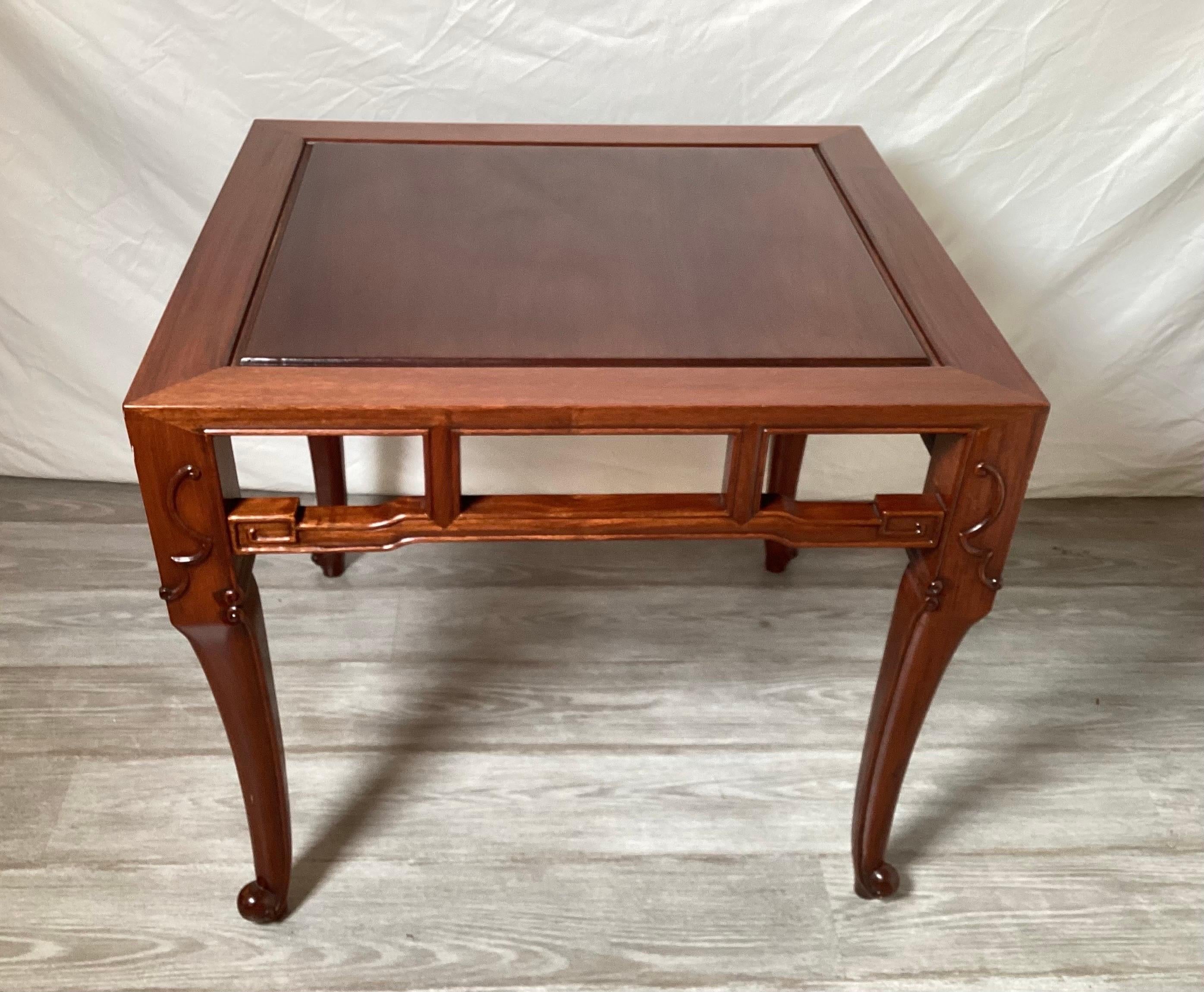 Table élégante et simple en bois dur chinois sculpté à la main avec un tablier magnifiquement détaillé.  La table a une profondeur de 24, une largeur de 25 et une hauteur de 27.  La partie supérieure est volontairement un peu plus foncée que les
