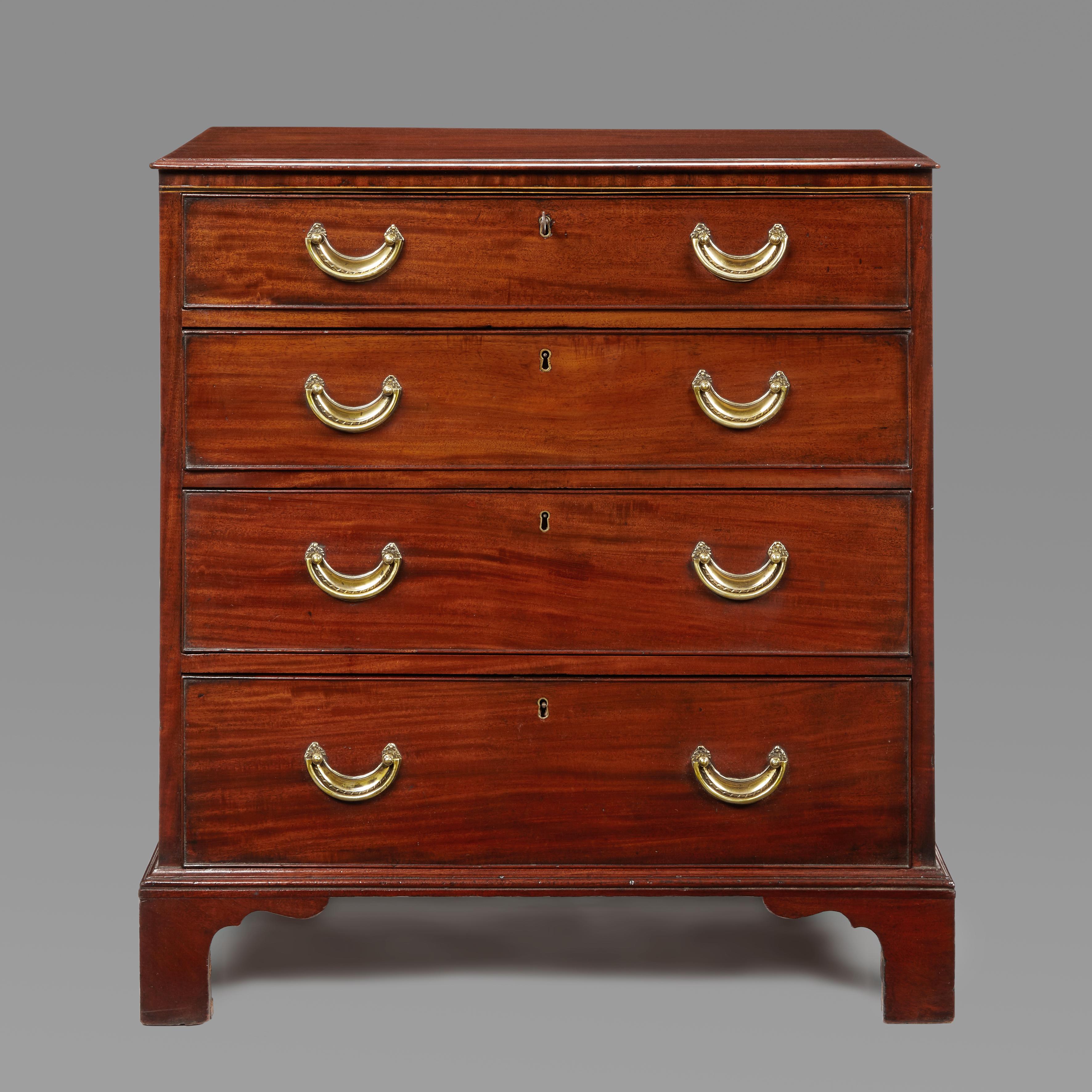 A Small Hepplewhite Period Mahogany Four-drawer Chest of pleasing Small proportions. The moulded top with an ebony and boxwood line inlay below .The cock-beaded drawers fitted with the original plate handles leading to bracket feet which are also