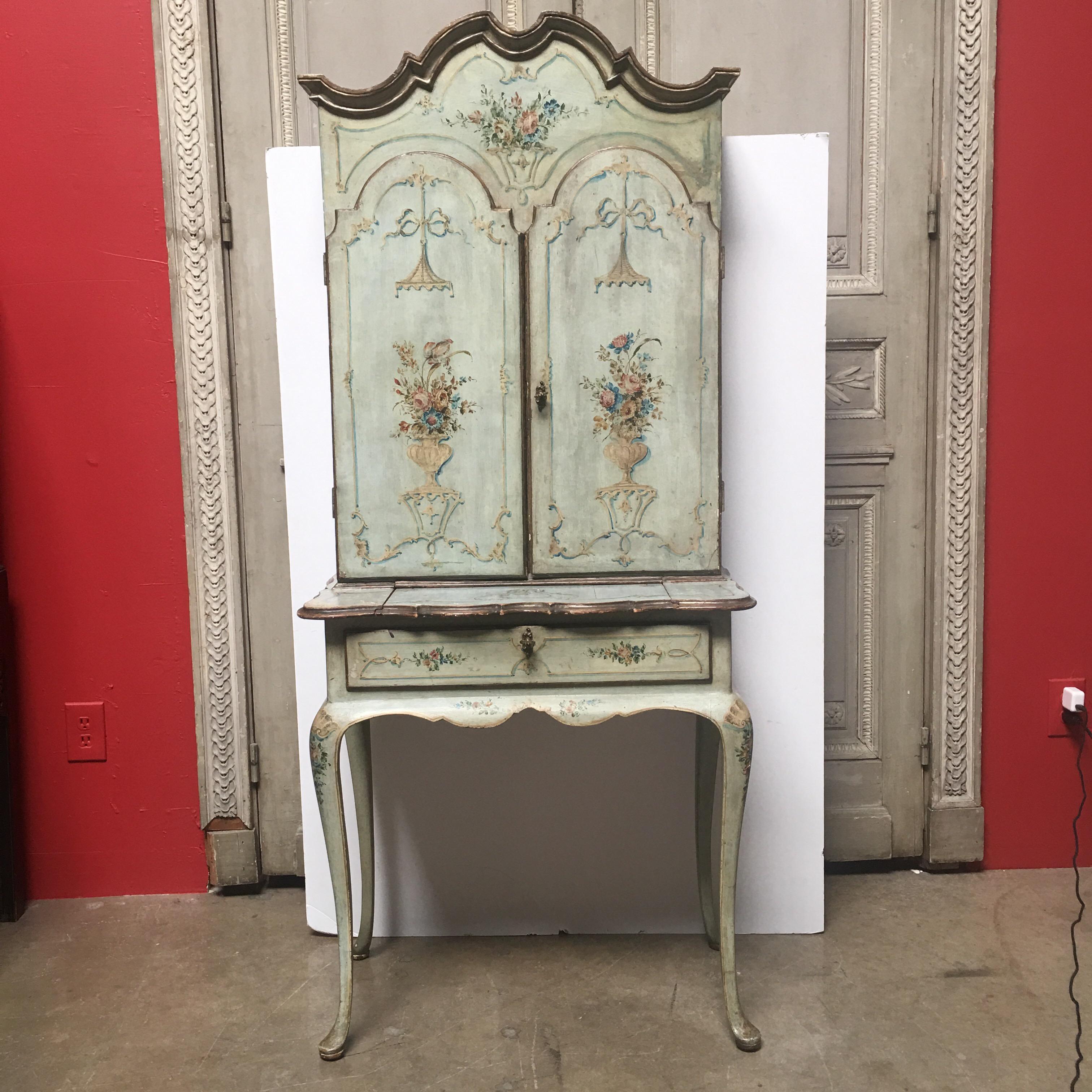 A late 19th century Italian painted secretary in a powder celadon blue green.  This small scale two piece secretary is painted in a beautiful chinoiserie style depicting classical scenes and flowers. 