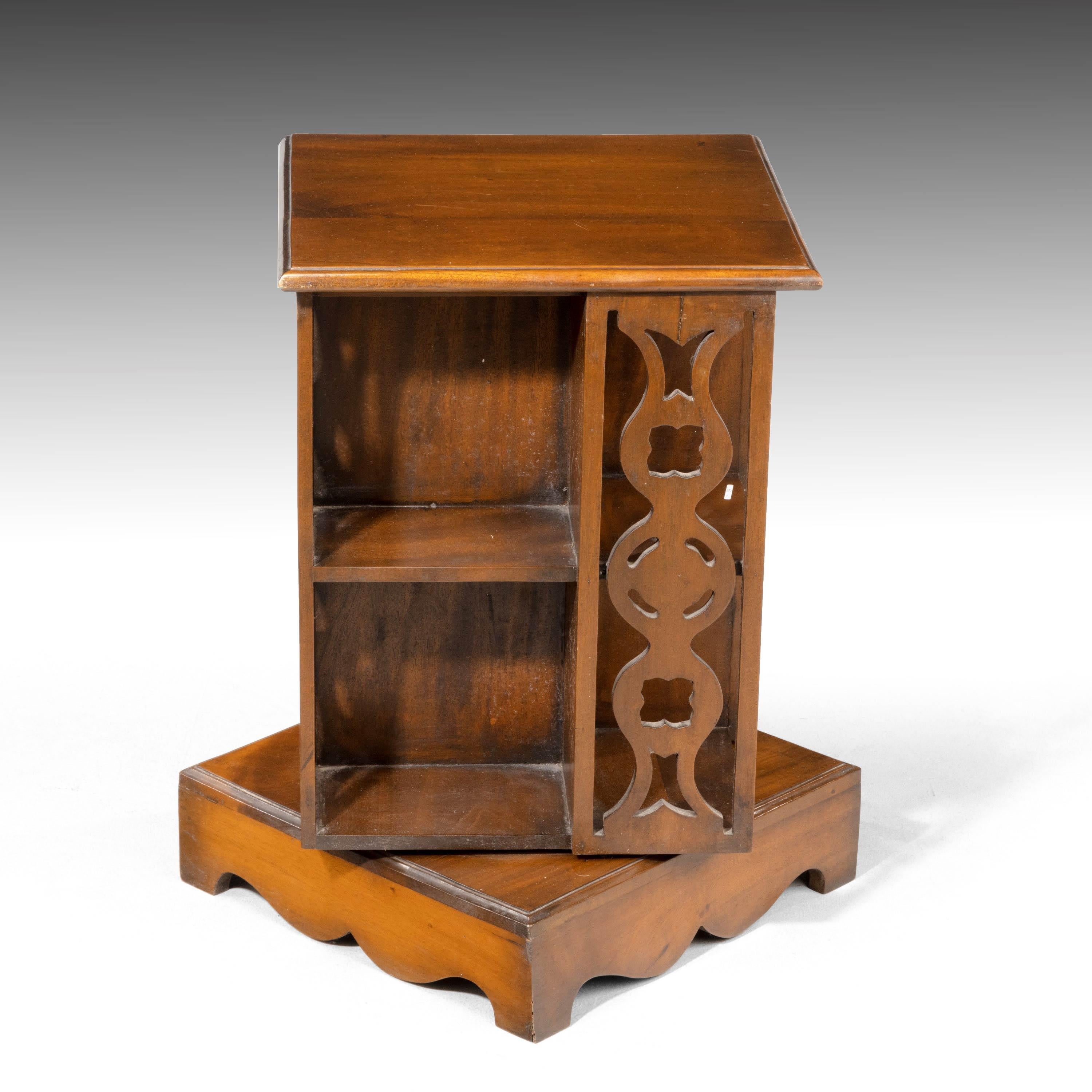 A small mahogany revolving bookcase. Of particularly unusual construction with elegantly pierced uprights to the restraining bars. Square section on shaped base.
     