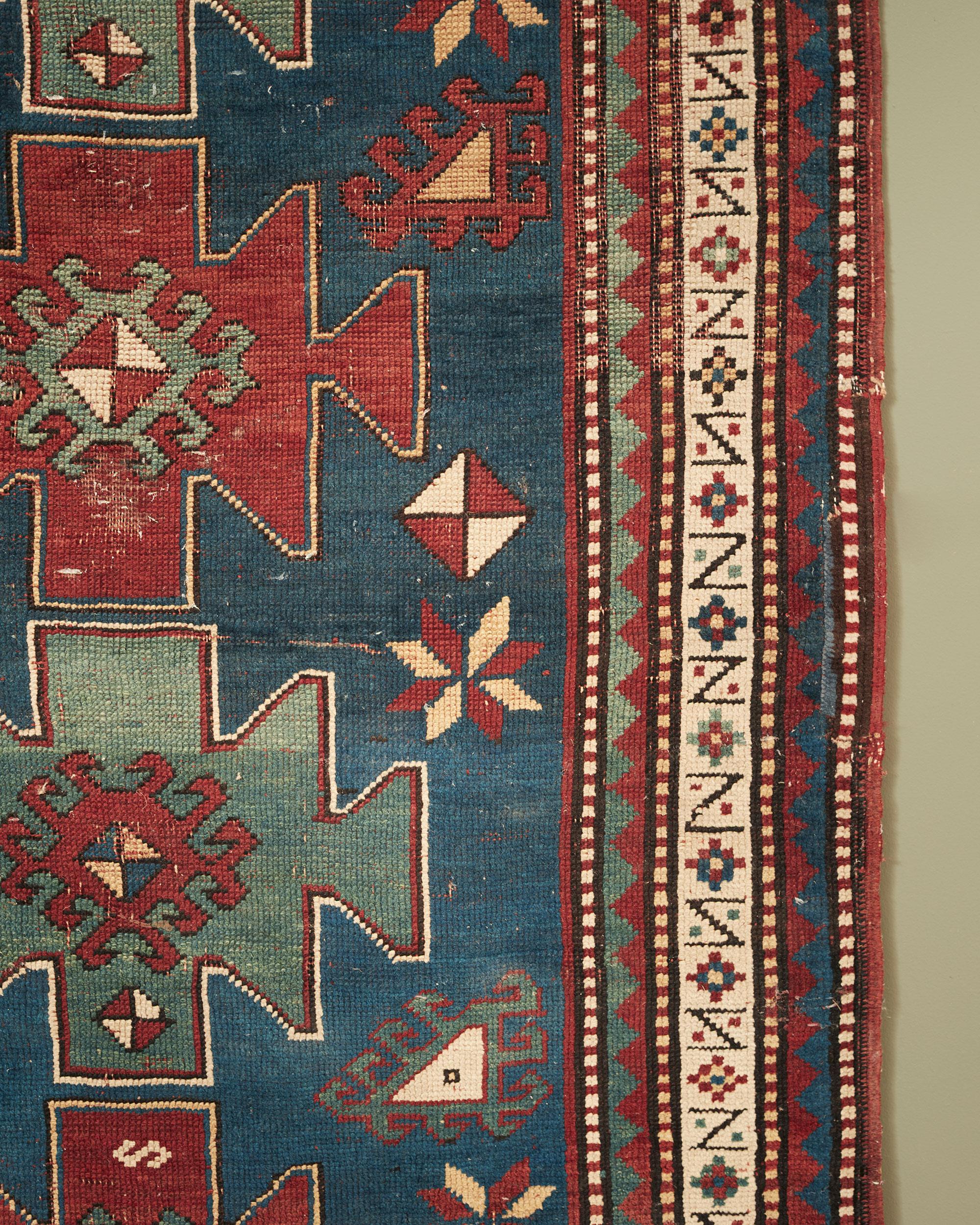 With muted colours of indigo and madder red, with stylised cruciform patter, and geometric meander border, most likely Armenian.