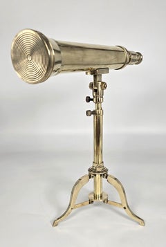 A small mid 19th C brass telescope with an original folding brass tripod stand