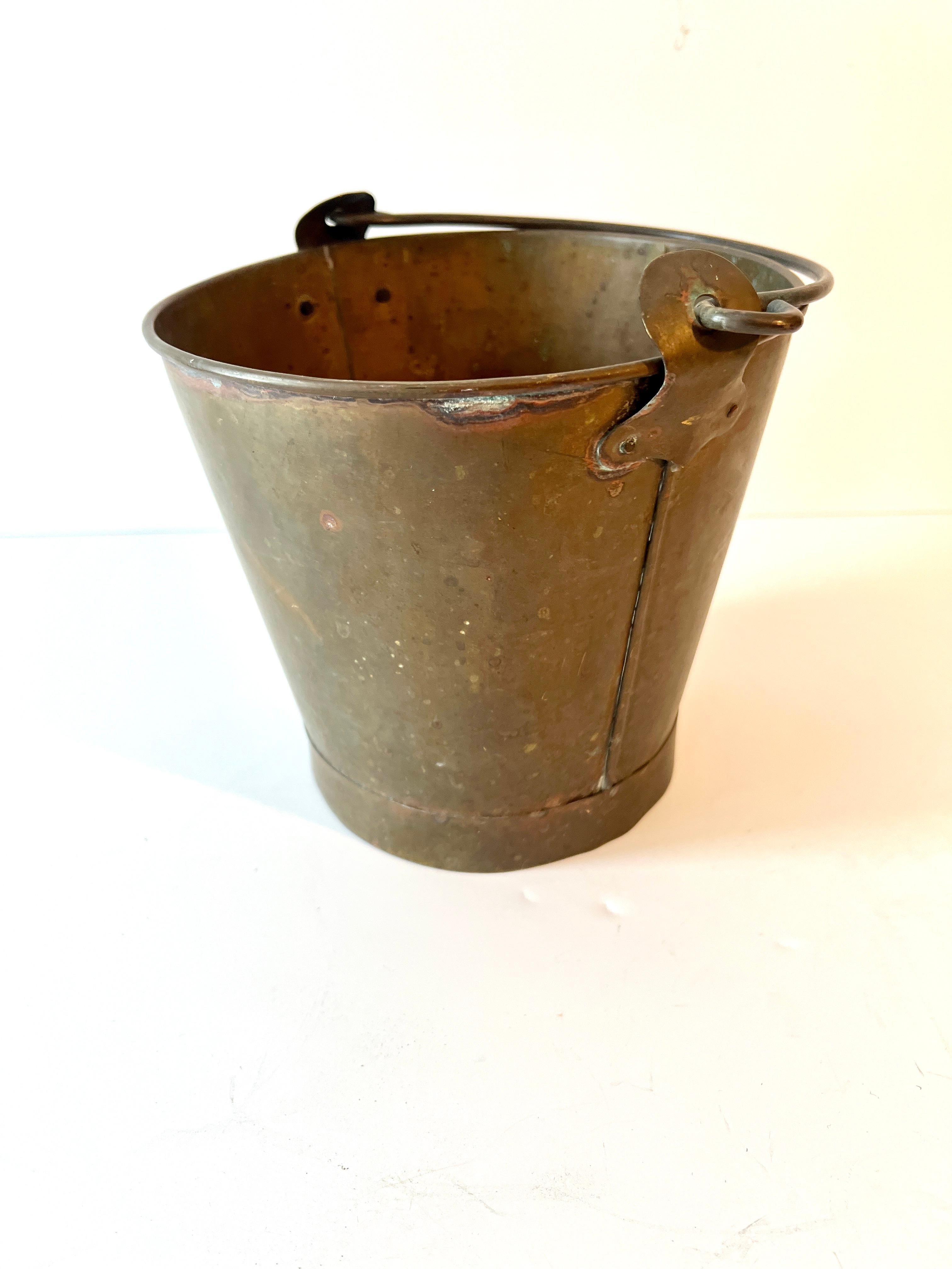 A simple and small solid brass pail.  The patination is perfect, making this piece a wonderful decorative piece, and also still great as a practical piece for the garden or compost.  Has a nice little handle too

Sometimes it's the small things that