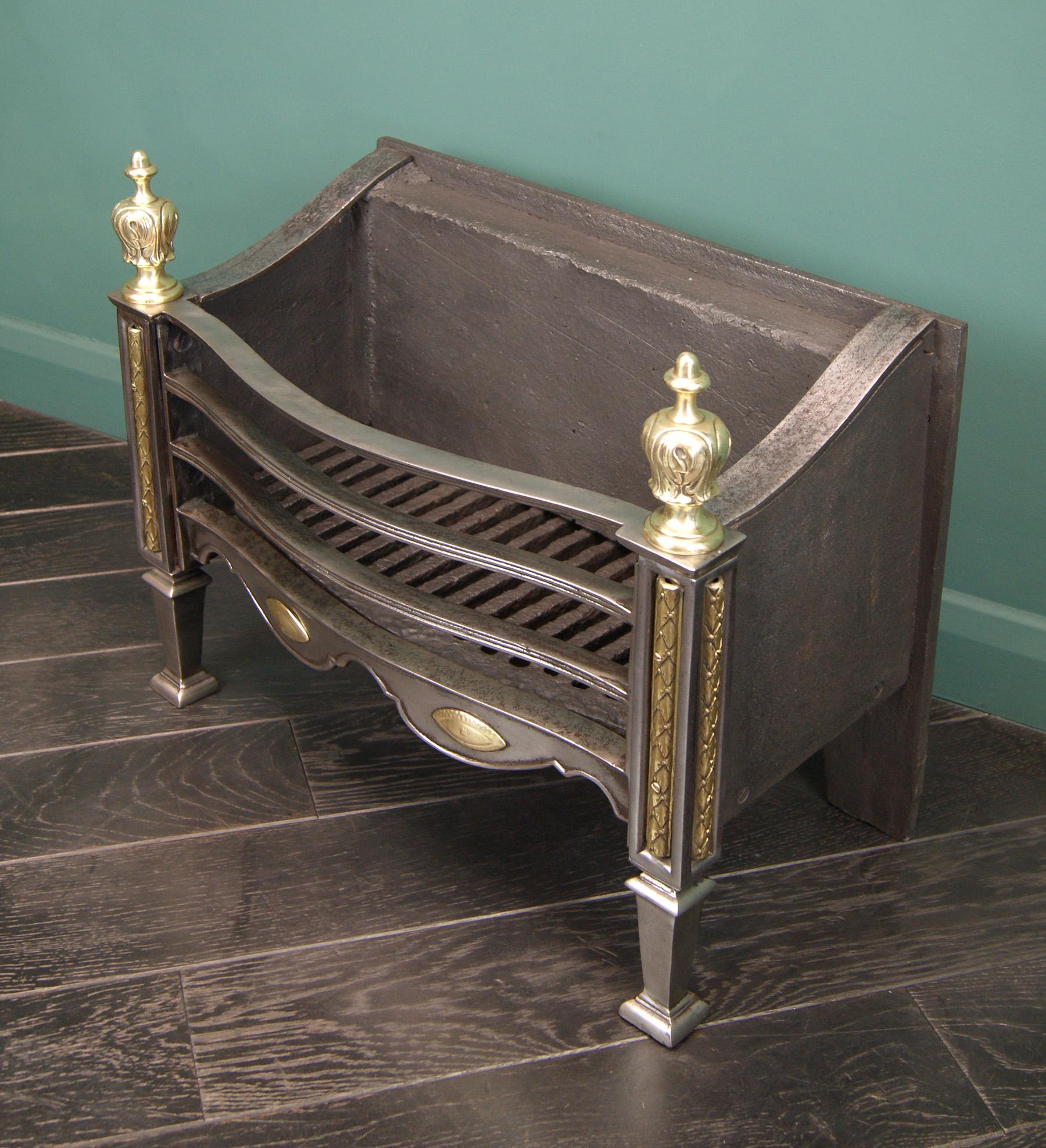 A finely cast polished brass and steel fire basket by Thomas Elsley, with reeded fire bars above a shaped fret with brass paterae, set between ornate panelled standards with tapered legs and decorative brass finials.  Restored.

Circa 1890.
