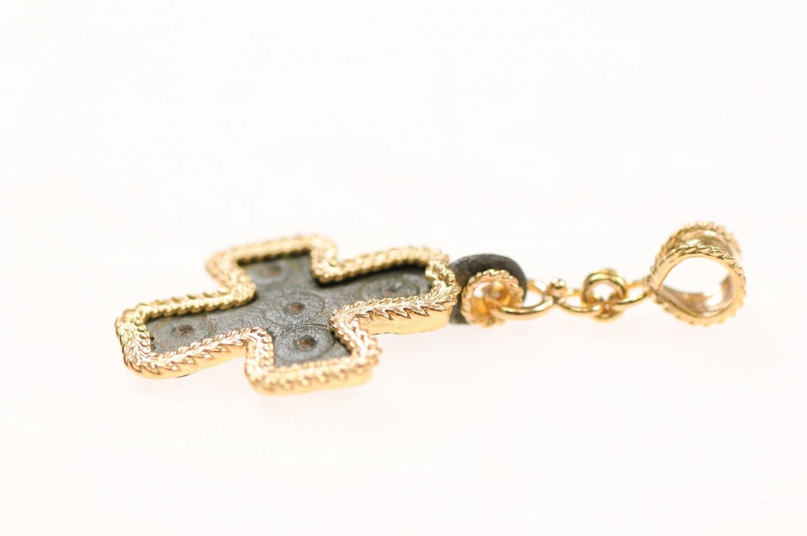 A small bronze cross fashioned into a pendant and accented with 21K gold. This from the 7th to 9th Century AD and was created by lost-wax casting and small circle details were hand-chiseled. This is an artisan-made custom piece with precious metal