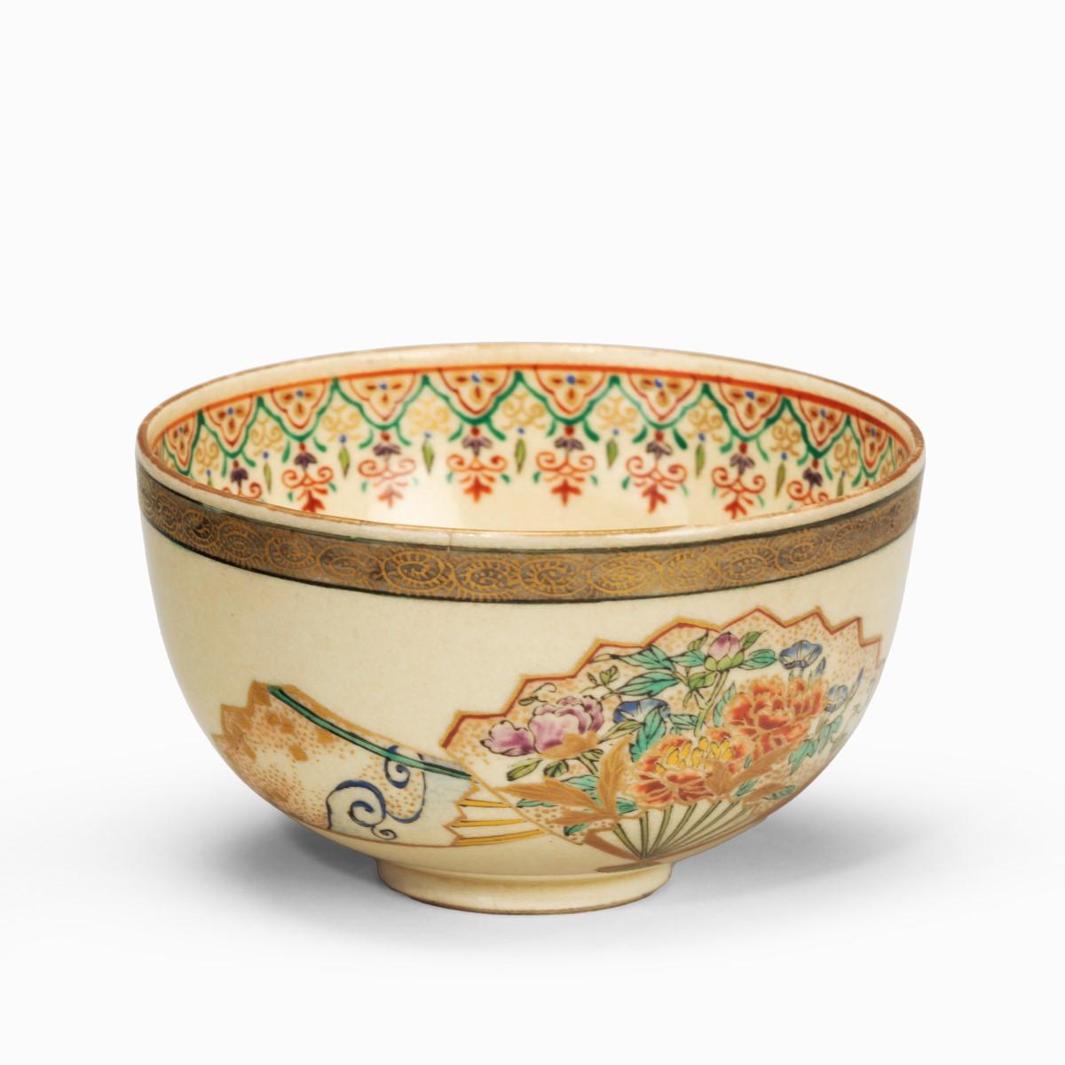 A small Satsuma earthenware bowl, painted in overglaze enamels and gilt with three fans. Japanese, circa 1900.

Measures: Height 2 inches Diameter 3 ½ inches.