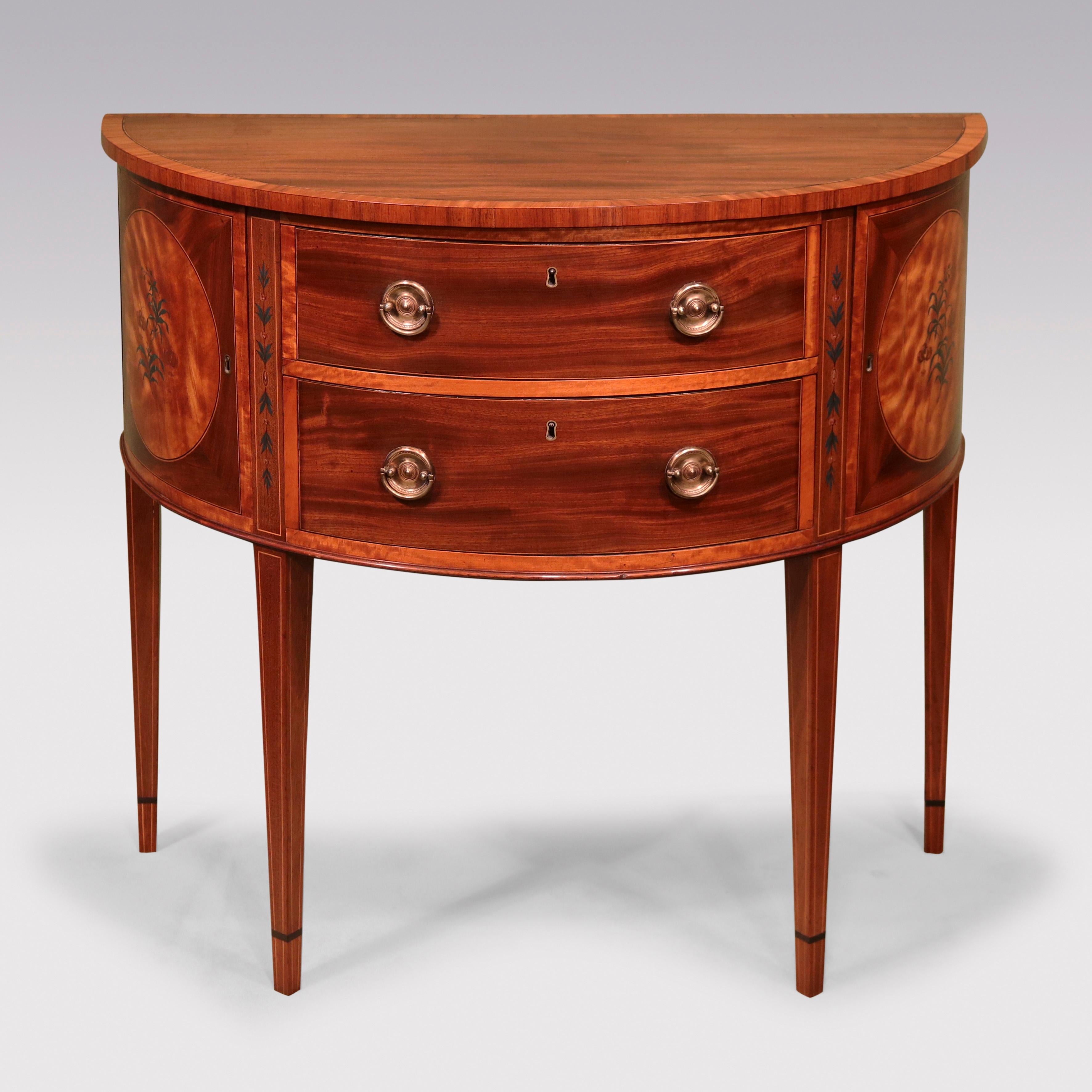 An unusual Sheraton half-round “Commode” bearing label: A & M Coleridge Collection, having satinwood crossbanded half-round top above 2 central drawers retaining original handles, flanked by satinwood & floral painted panelled doors supported on