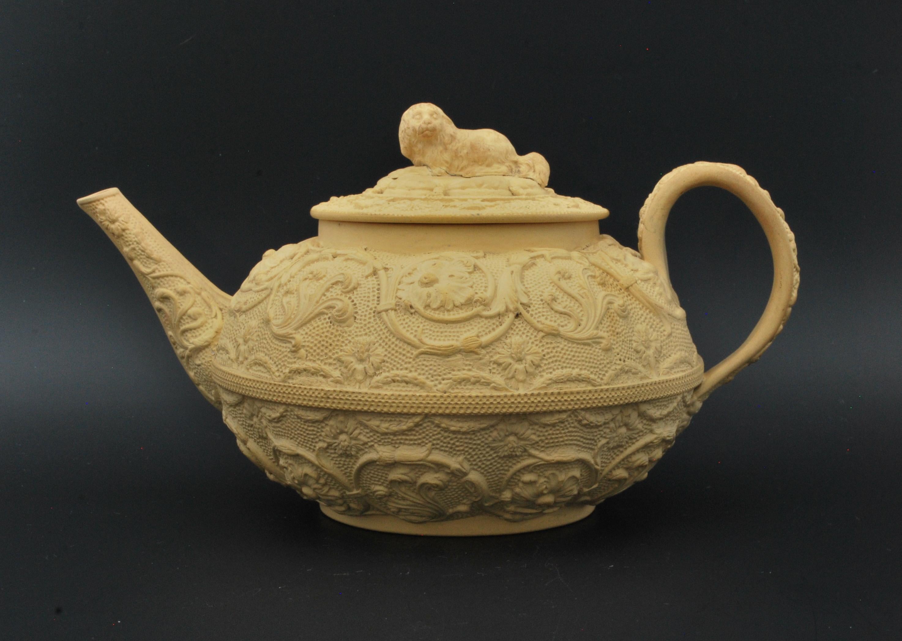An unglazed caneware teapot of depressed oval shape, with arabesque decoration and a spaniel finial.

Wedgwood caneware is a type of pottery that was first produced by the Wedgwood company in the late 18th century. It was named 