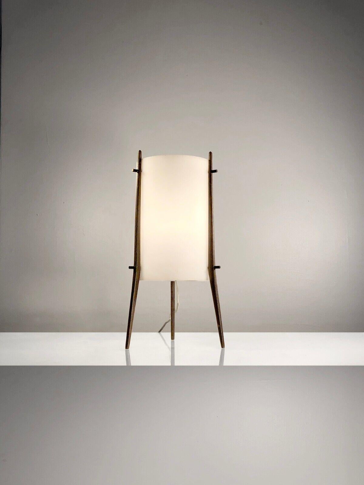 A small tripod table lamp or night light, Modernist, Space-Age, Fifties, cylinder in white satin perspex diffusing light mounted on 3 elegant teak legs, stamped Alfaplex Milano, Italy 1950-1960.