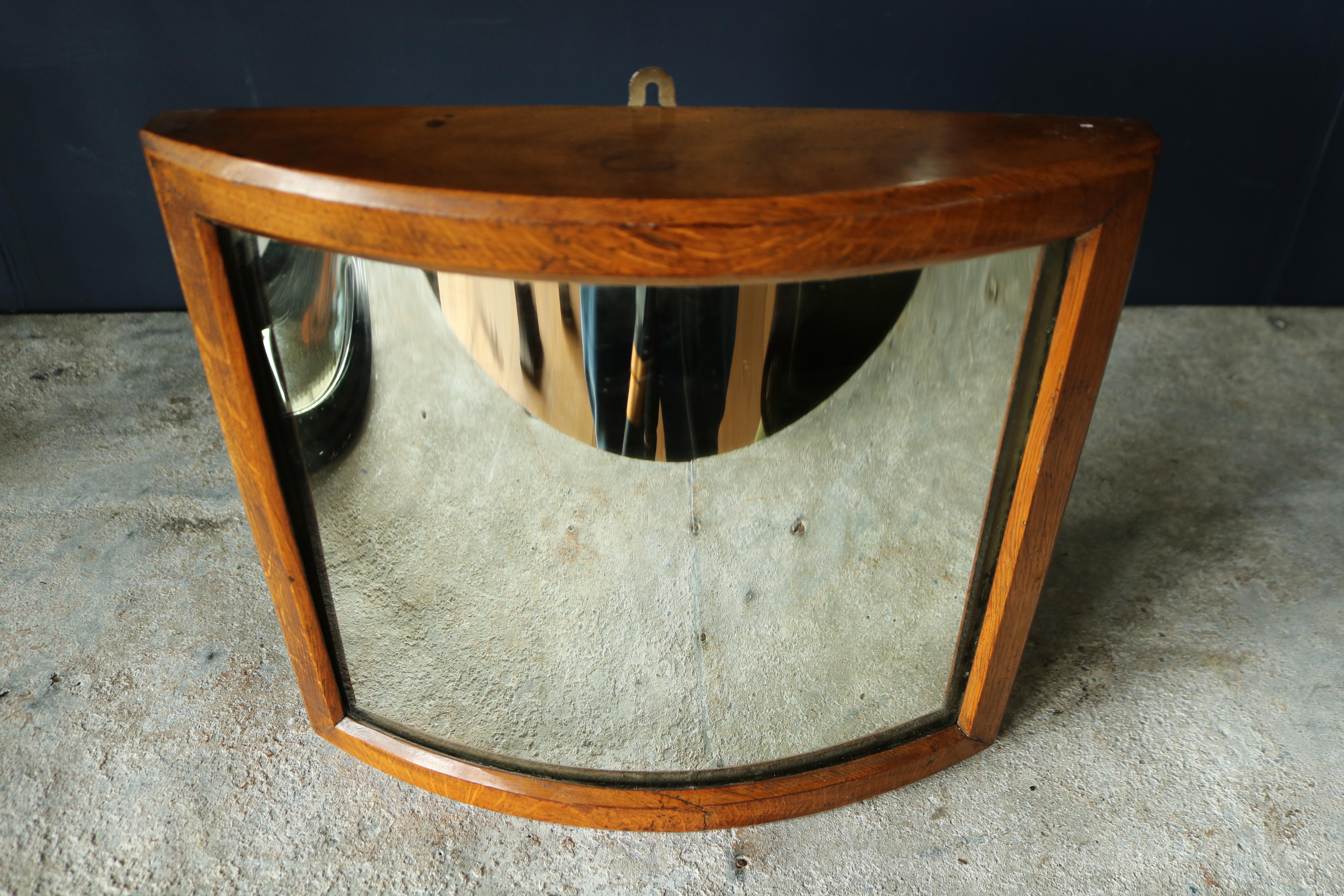 A late 19th century fairground mirror set in a beautiful golden oak frame with its original distortion mirror plate.