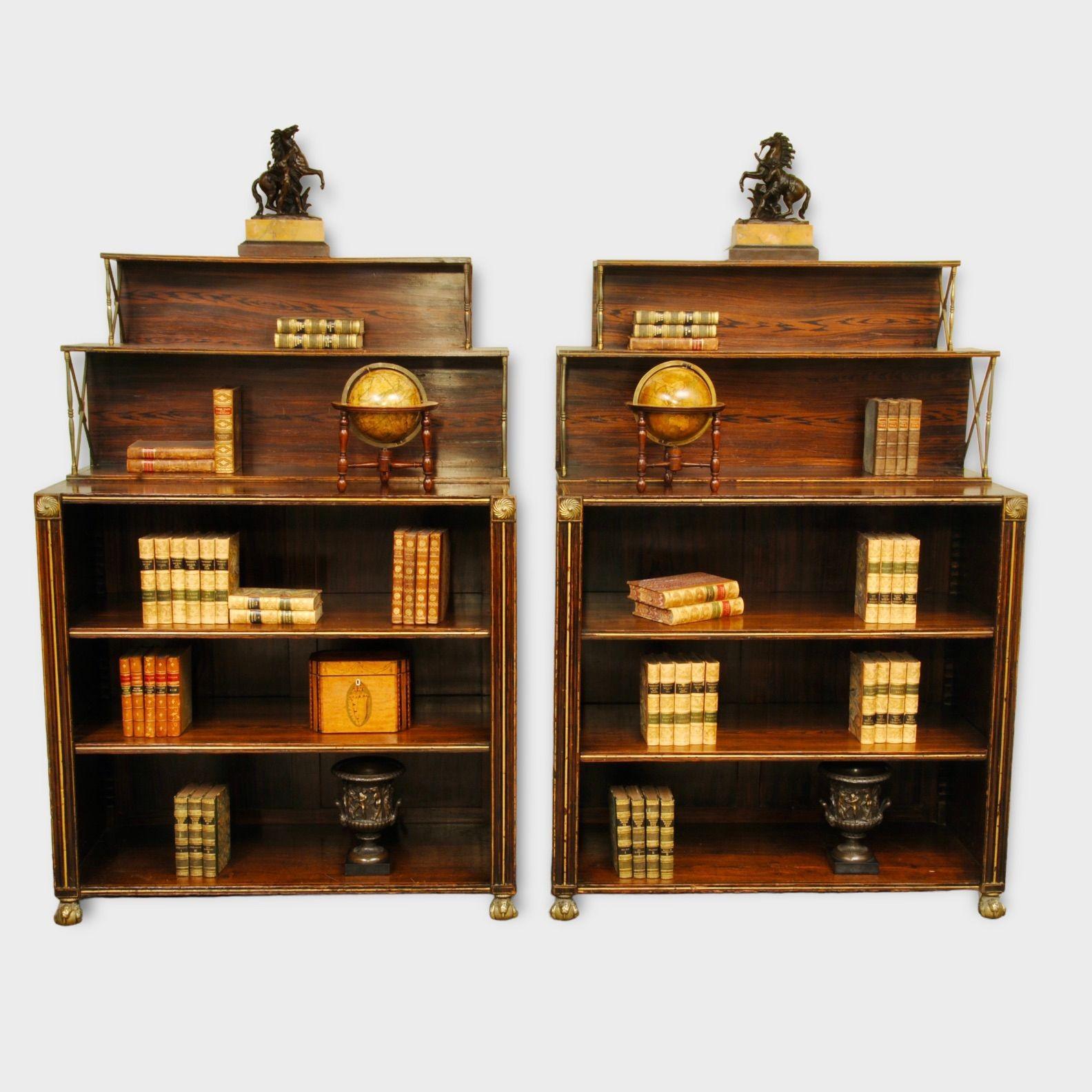 An unusual pair of finely grained rosewood open bookcases with gilt line decoration. The top shelves with elegant brass supports and with brass paw feet, the original painted rosewood decoration is in superb condition.
Circa 1825.
 