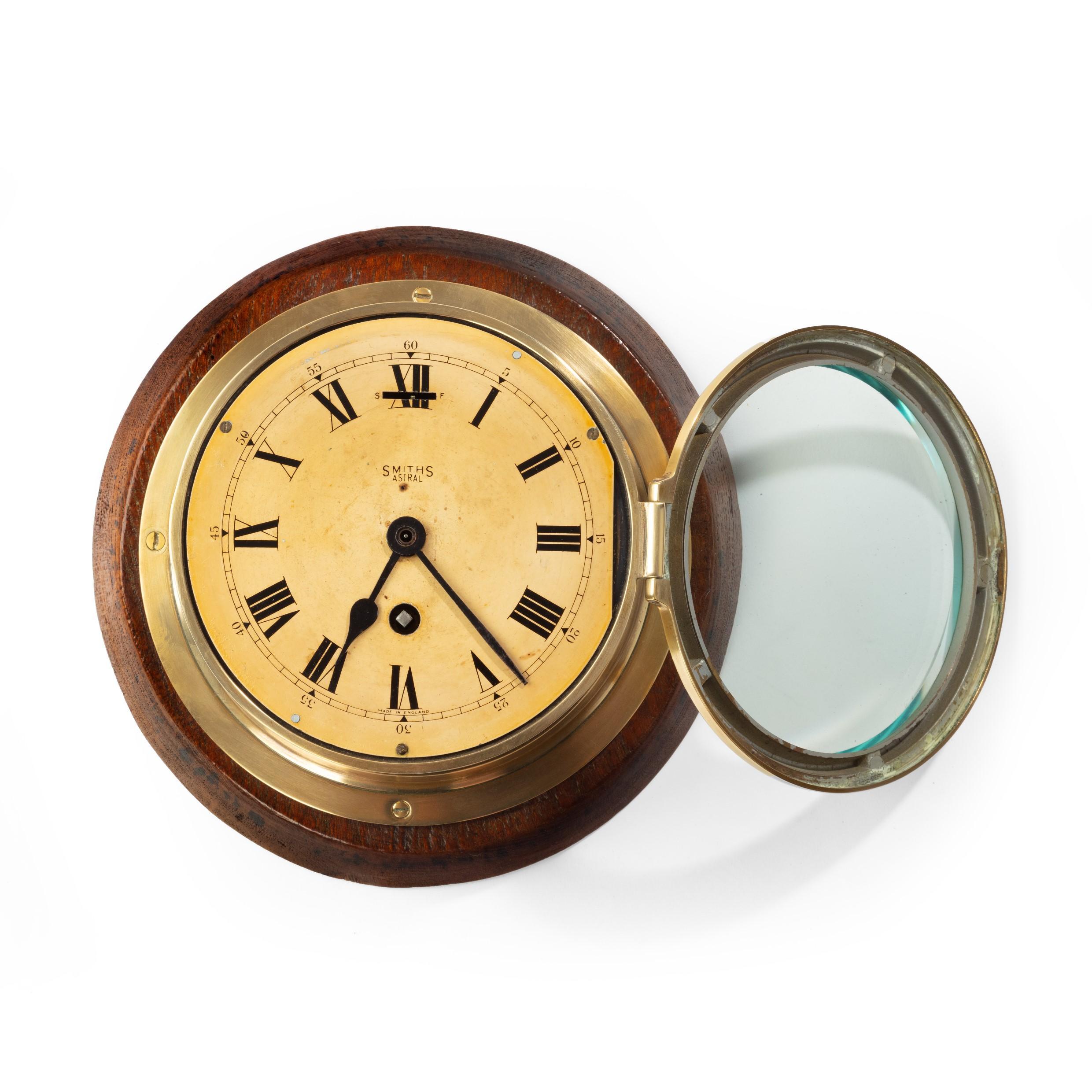 A Smiths Astral brass bulkhead clock, the opening front bezel with convex glass, the painted dial with roman numerals in black, signed ‘Smiths Astral’. English, circa 1935. 5.5 inch dial.
