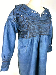 A smocked, glazed indigo linen blouse dress – Edwardian period