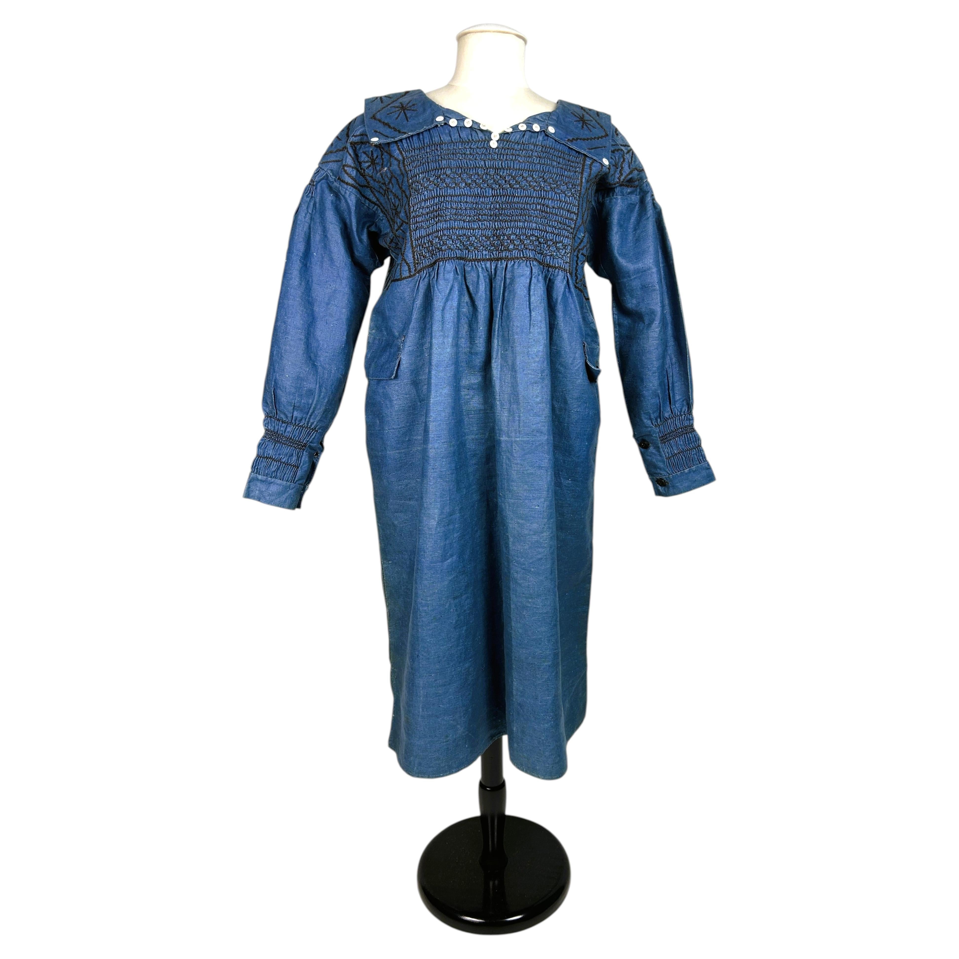 A smocked, glazed indigo linen blouse dress – Edwardian period