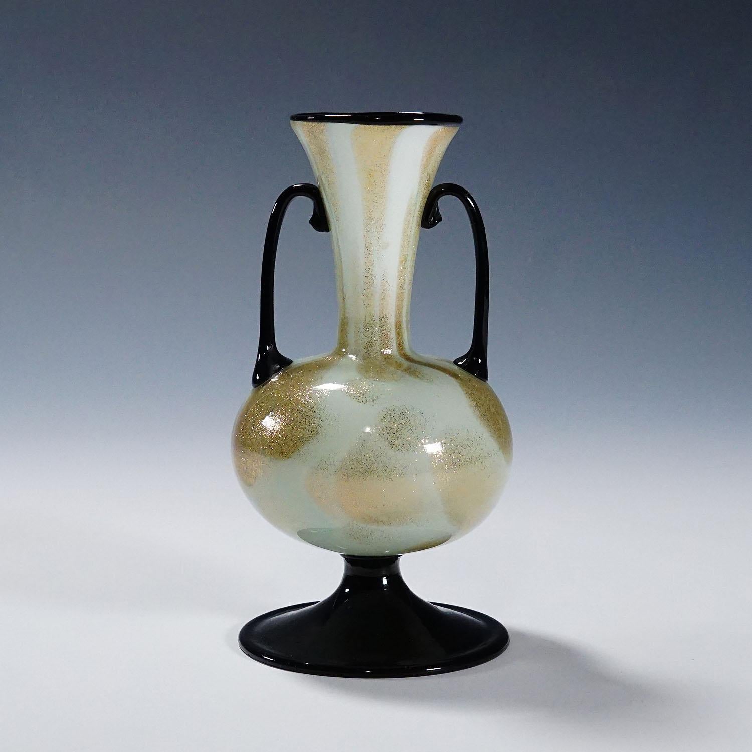 A Soffiato Glass Vase with Aventurine by Fratelli Toso (attr.), Murano ca. 1930s

A rare Murano art glass vase manufactured most probably by Fratelli Toso around 1930s. Thin opaque white glass with aventurine inclusions and applied foot, handles and