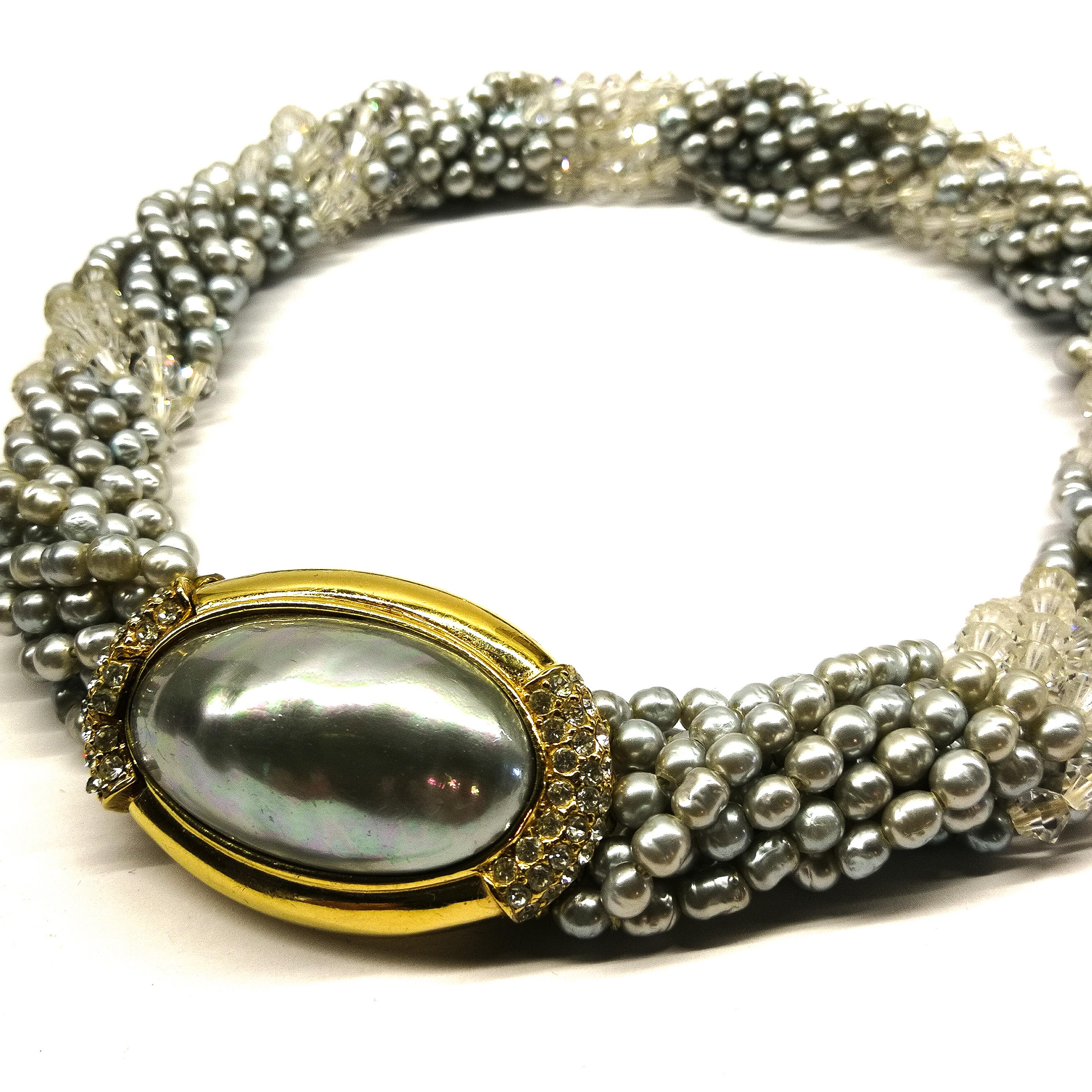 A very elegant necklace, made from soft grey baroque paste pearls and faceted crystals, in a 'twist', meeting in a large gilt and paste clasp, with Mabe style soft grey paste pearl at its centre. Made by Ciner, always a name for the highest quality