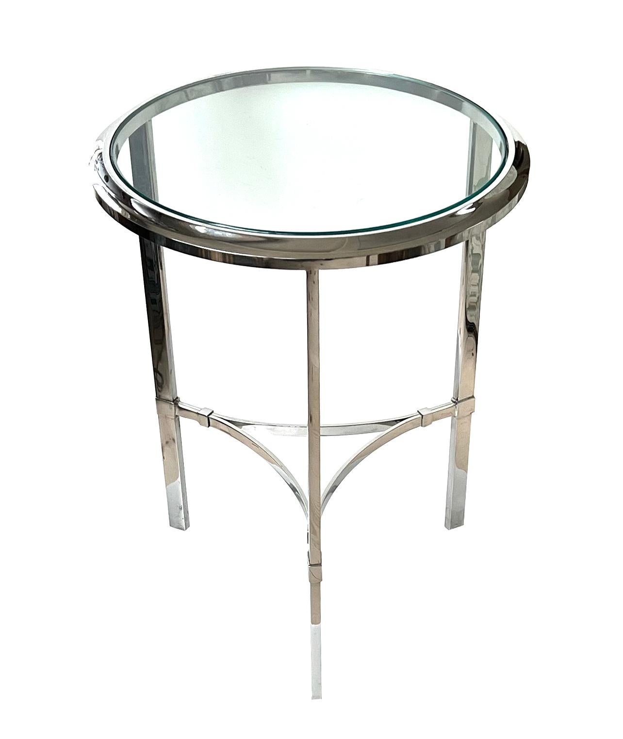of solid heavy construction with round glass inset top within a thick coved molded frame; all raised on three rectilinear supports joined by concave stretchers