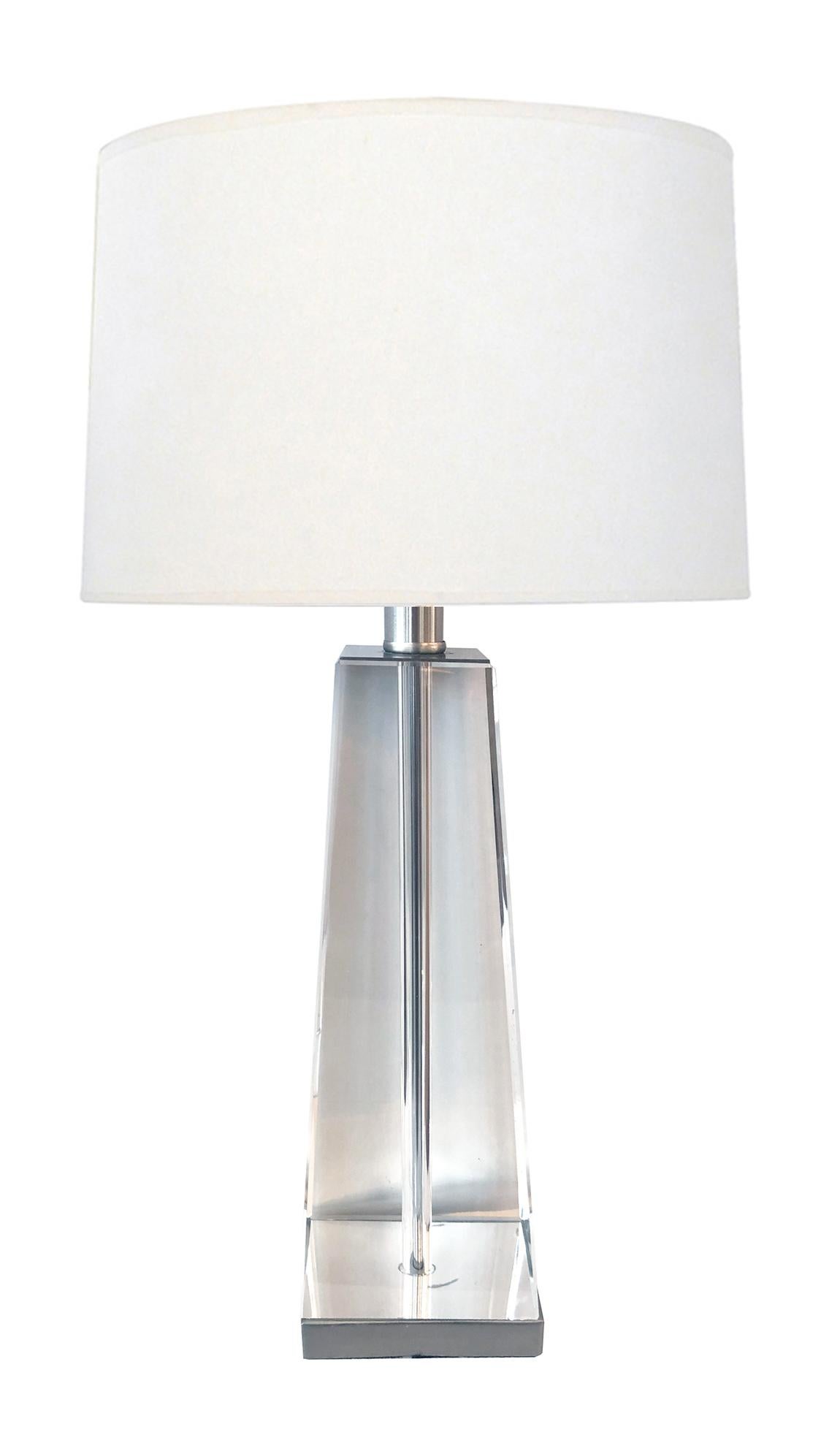 a versatile lamp that can be used in multiple settings, of thick hand-polished crystal with its ethereal reflective quality allowing light to penetrate changing from day to evening; all resting on a brushed chrome base; the obelisk was originally