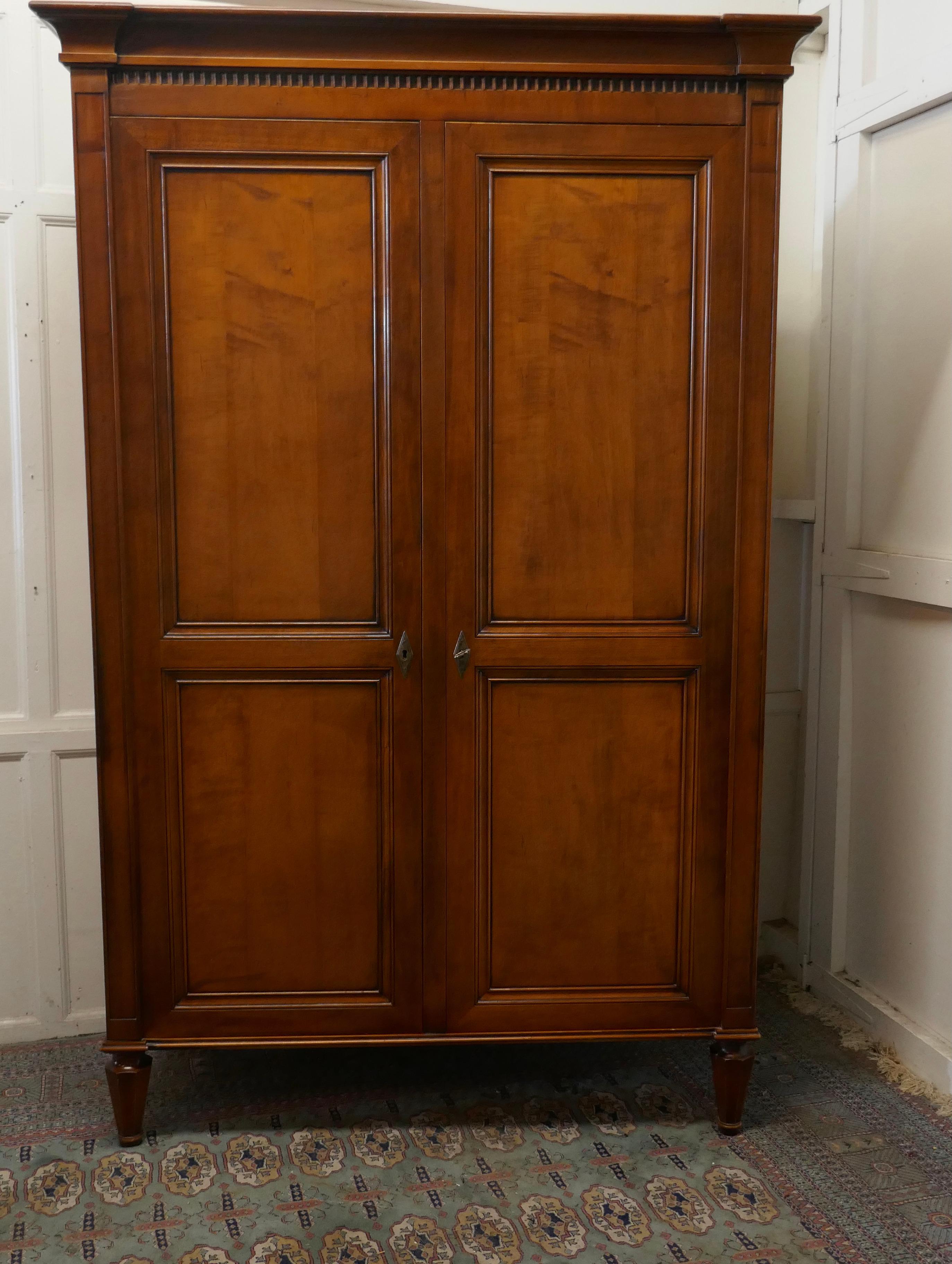 A solid fruitwood shelved armoire & hanging wardrobe

This is a very attractive piece, the Wardrobe is a good quality piece, it has 2 panelled doors, enclosing a full length hanging wardrobe and another section with both hanging and adjustable