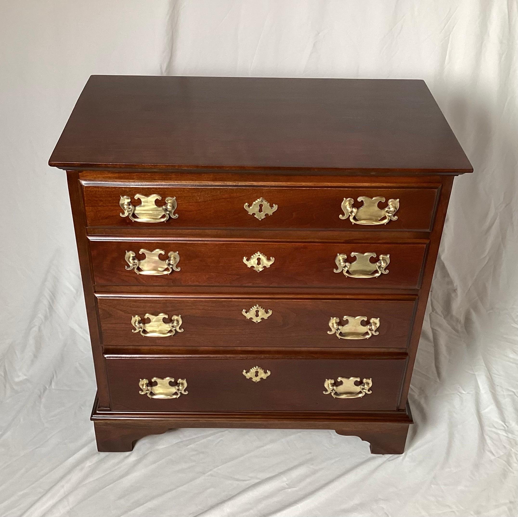 Solid Pennsylvanian cherry diminutive bachelors chest with brass handles. The warm dark reddish brown wood with burnished brass handles. The back is a solid beveled panel of polished and finished wood. Pennsylvania house was finely made solid wood