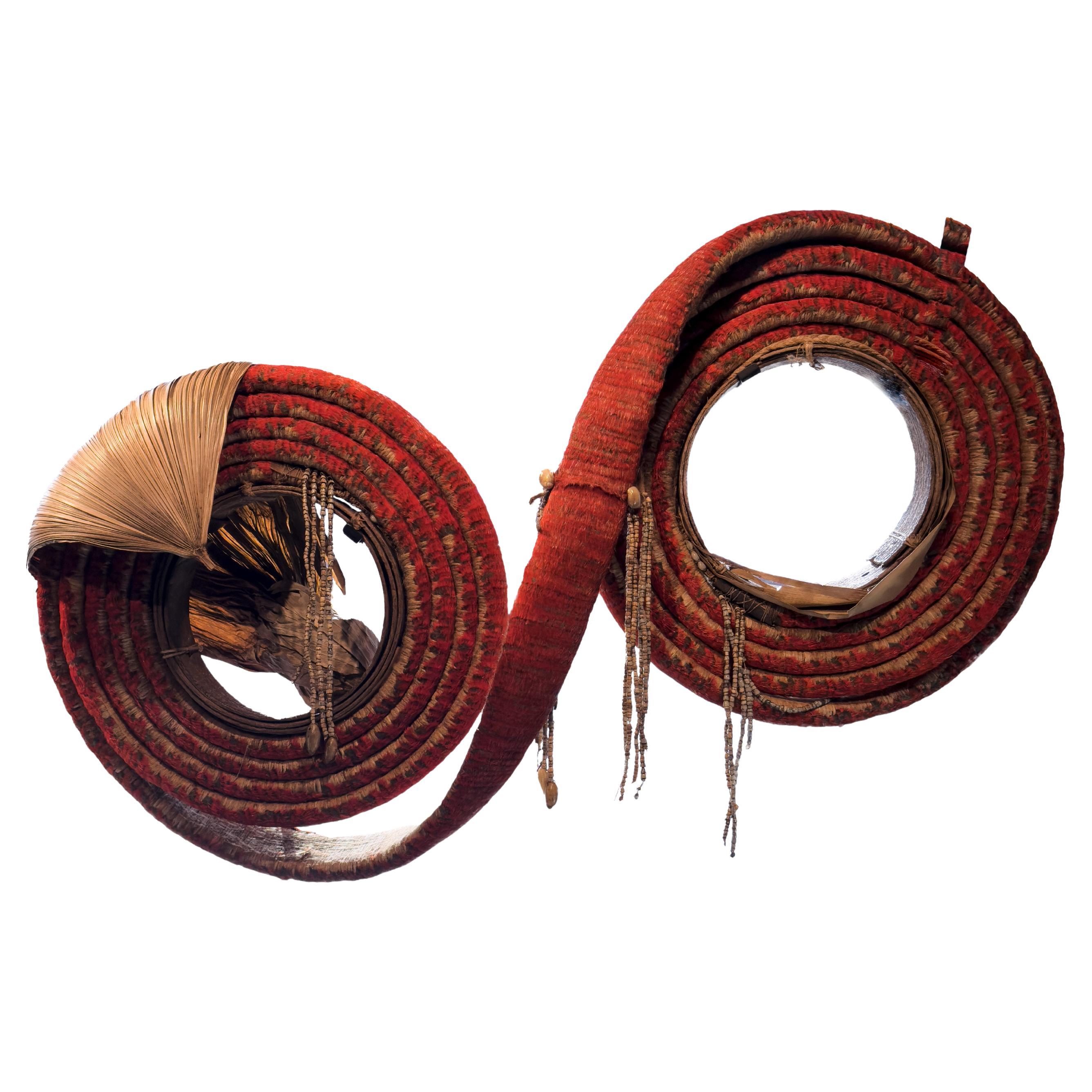 A Solomon Islands red feather money coil or 'Tevau'