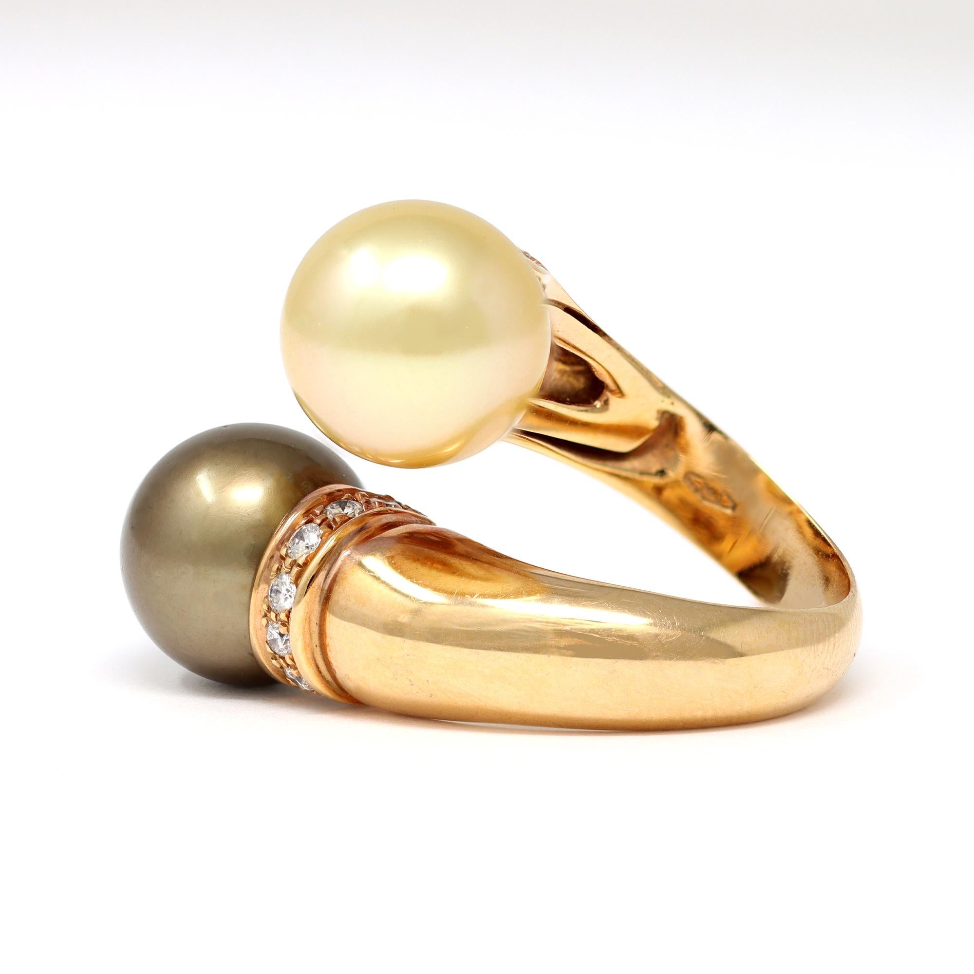 A fine by-pass ring featuring a natural gold south sea pearl and a grey Tahitian pearl with diamond accents. The ring was originated in Italy circa 2000. The round pearls measure 11 millimiter with great luster and very minor surface inclusions. The