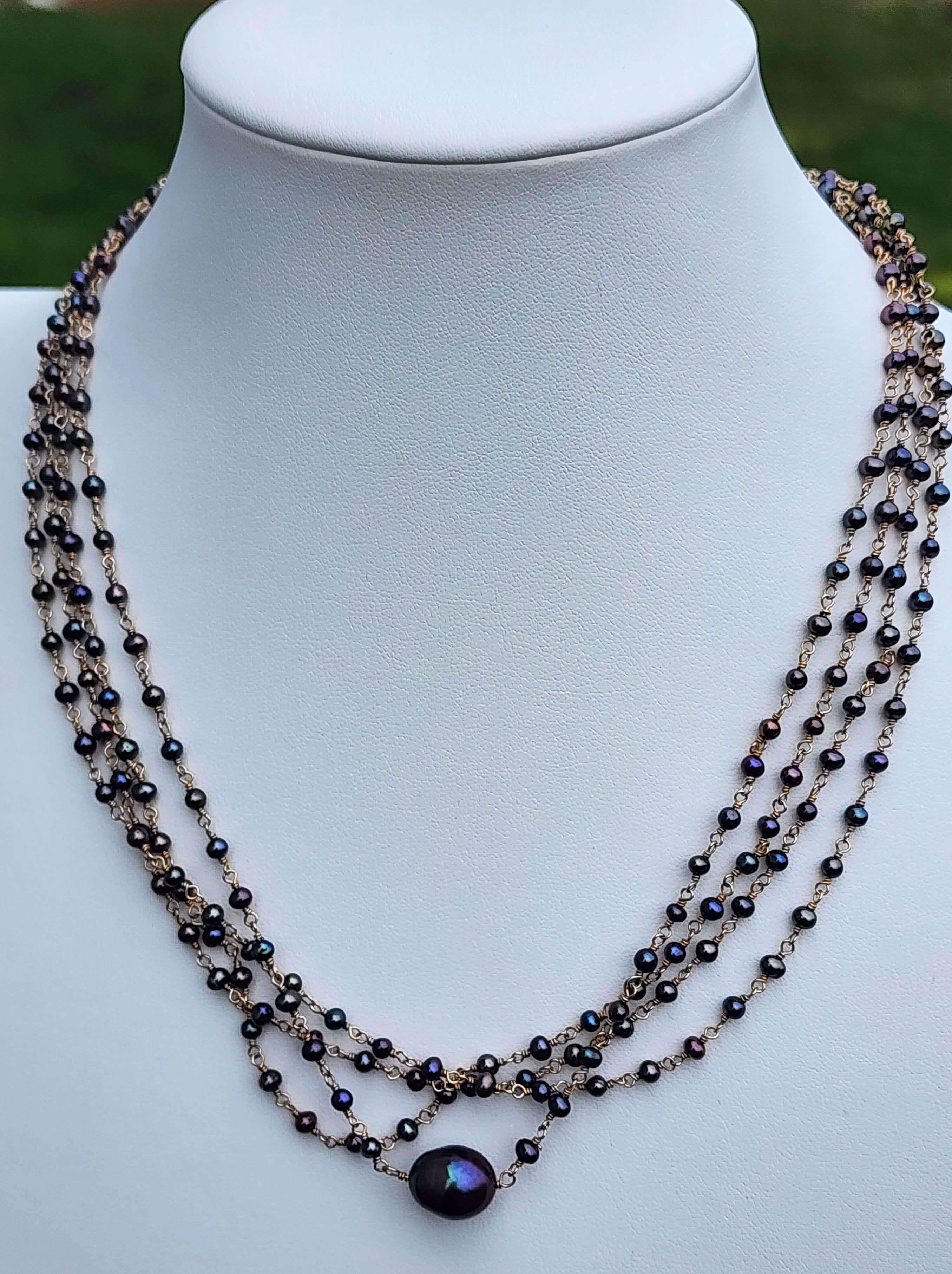 A South Sea Pearl Necklace of 75 inches total length meant to be trebled or quadrupled when worn. Comprised of 300 cultured salt water pearls each 3mm, and one large South Sea pearl 10.6mm x 12.8mm. Each pearl is drilled and strung with 14k gold