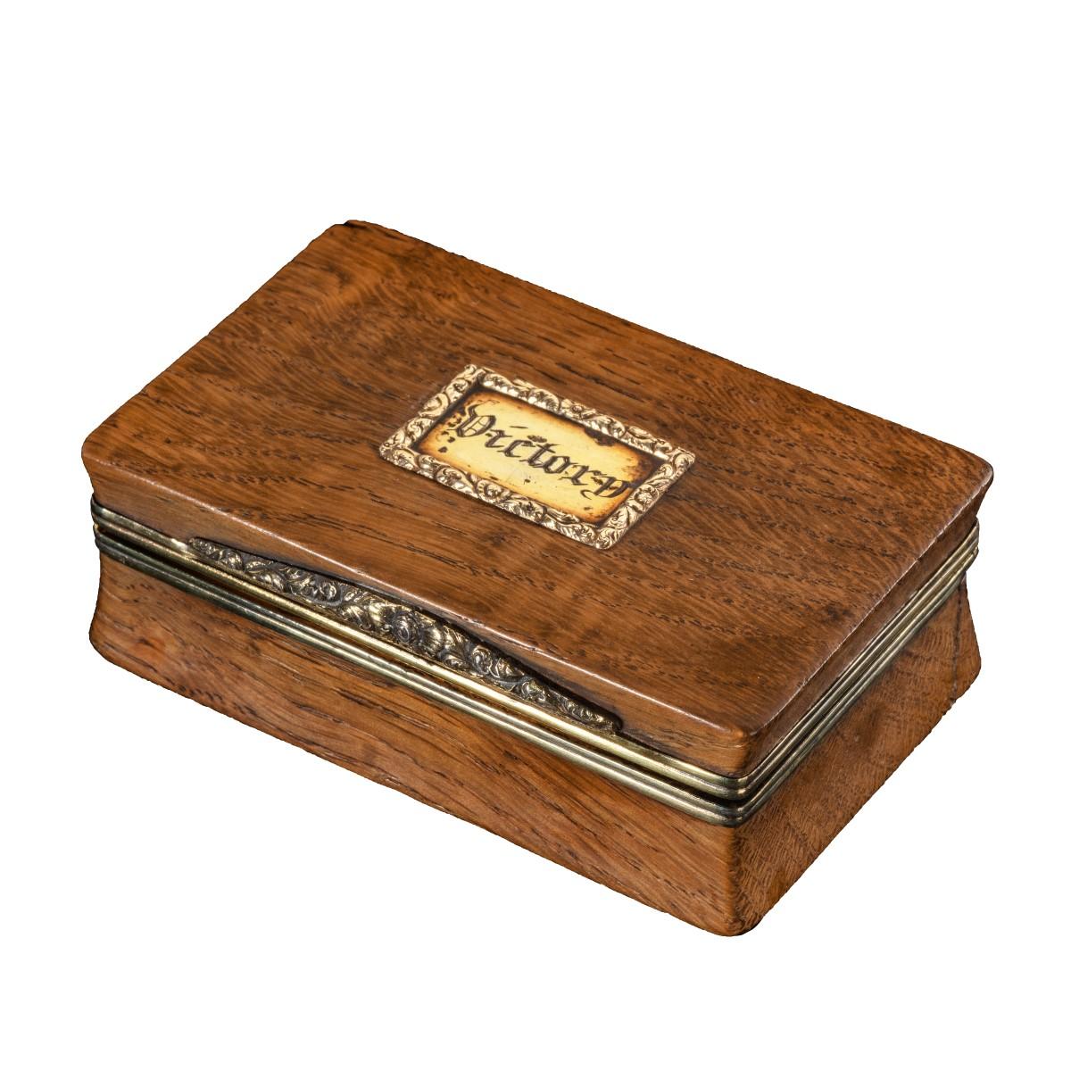 This small trinket box is of rectangular form with a hinged lid and applied with a silver gilt tablet engraved
‘Victory’ within a foliate border. With fully lined gilt interior. 

Hallmarked twice for 1819.

After the Battle of Trafalgar